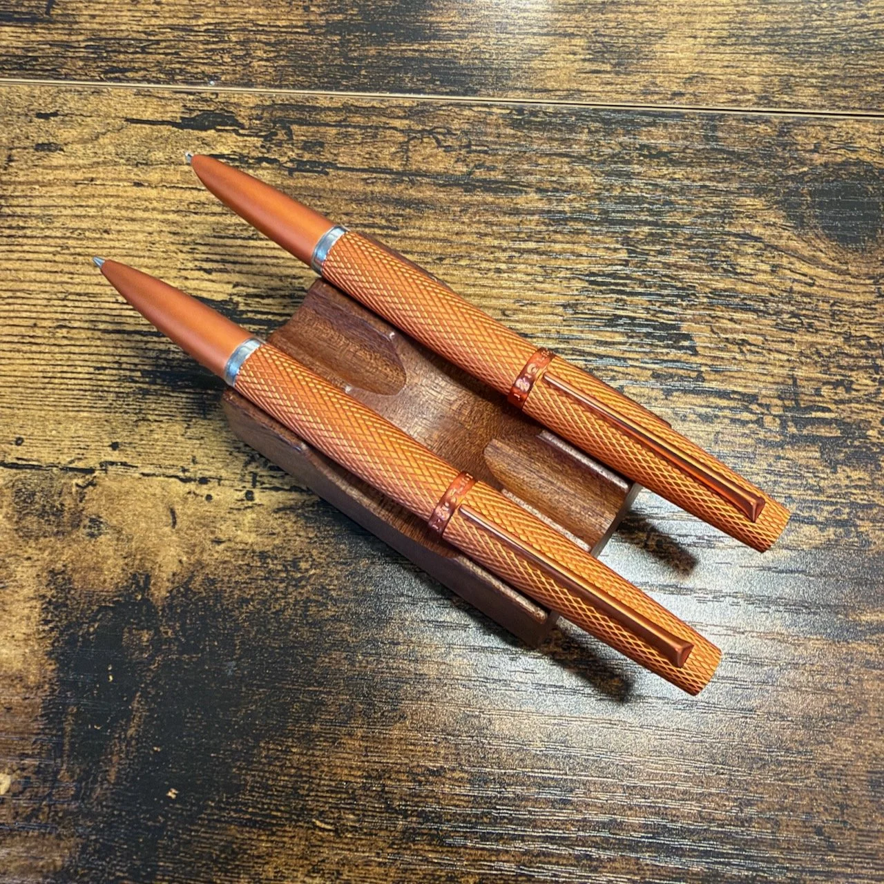 Diplomat Viper Fountain Pen and Rollerball in Orange Uncapped and Posted Side-by-Side on a Pen Stand