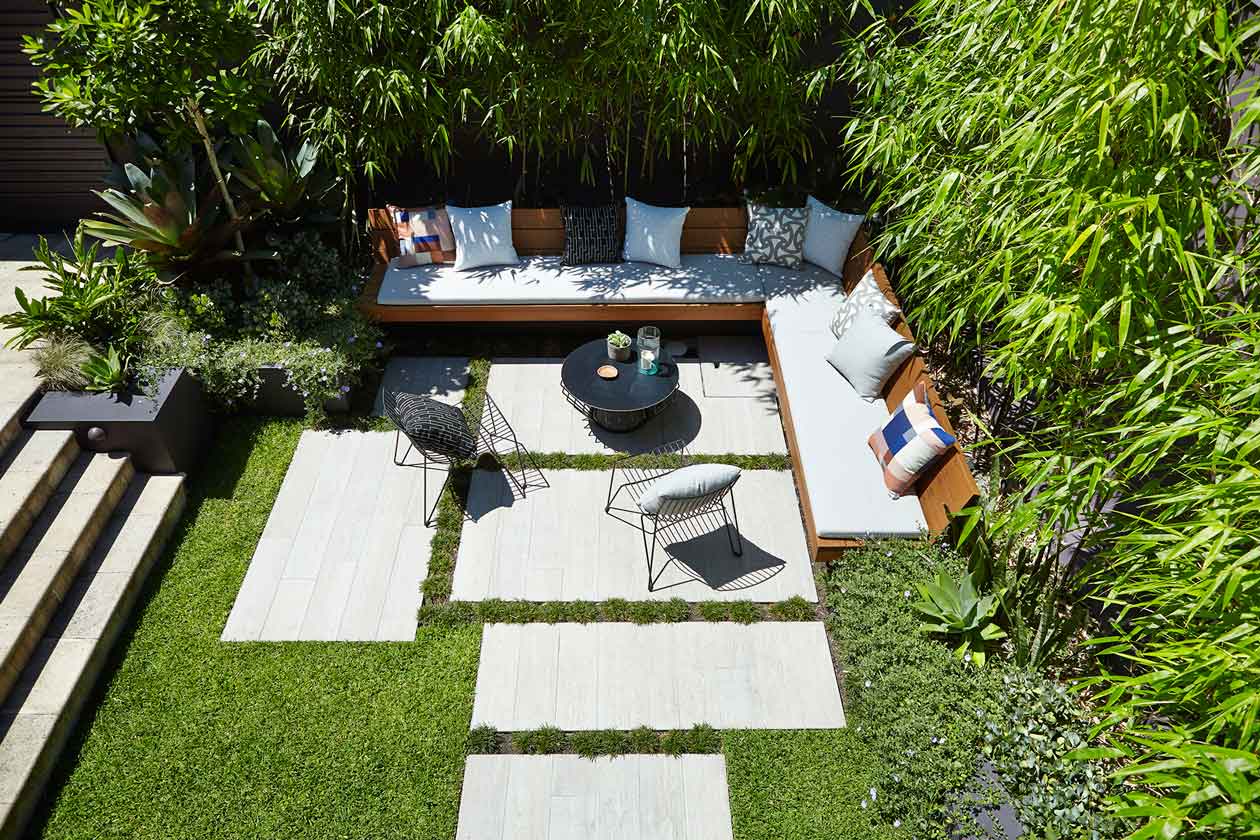 1. Darken a boundary wall to define an area and evoke a moody feel 2. Layer green-on-green to make your garden lush then add accents of coloured planting to compliment your space 3. Use oversized hardscaping or pavers to play with scale