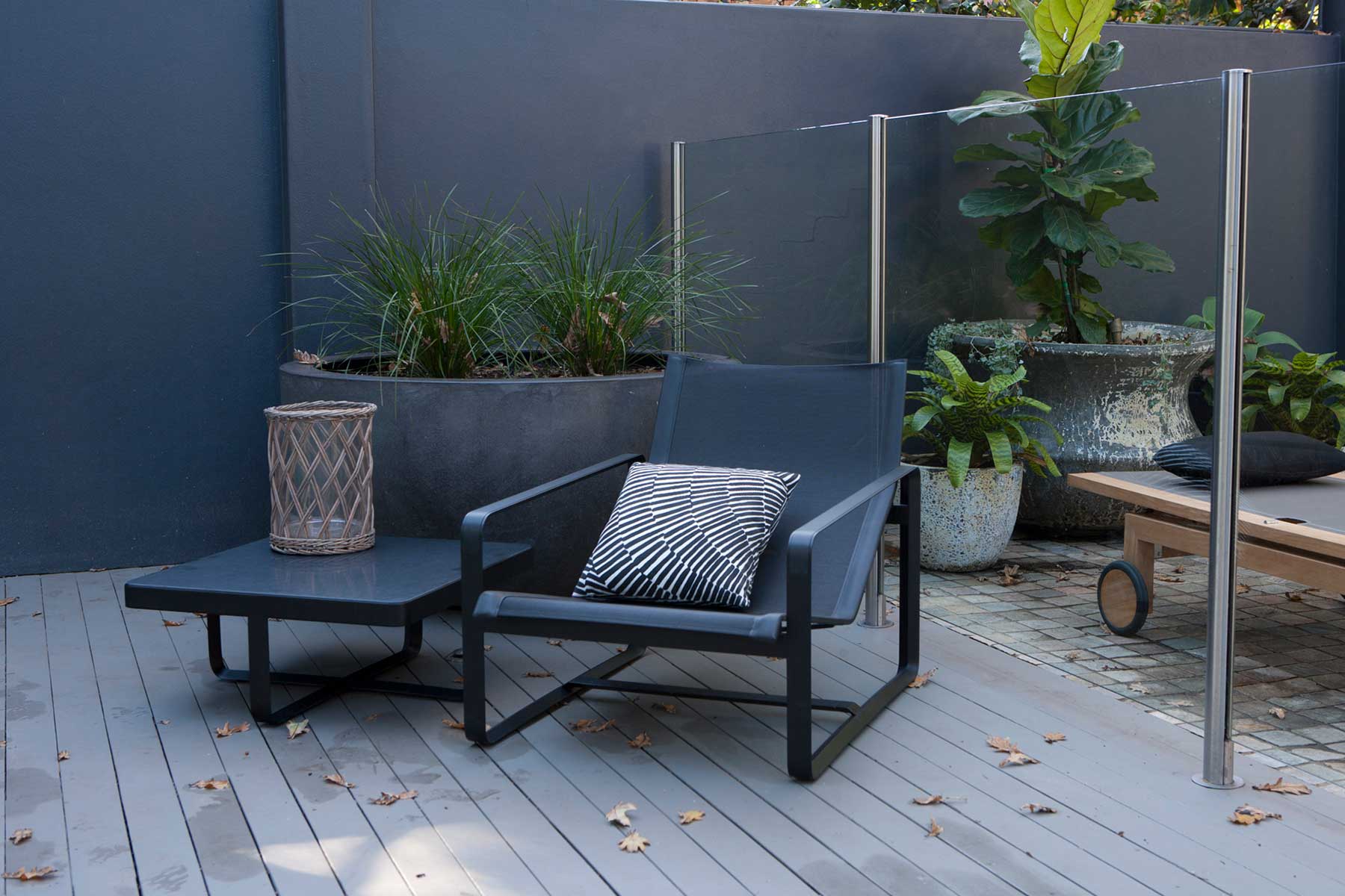 A sexy and sleek black, poolside accent chair from our Pymble Landscape Design Project
