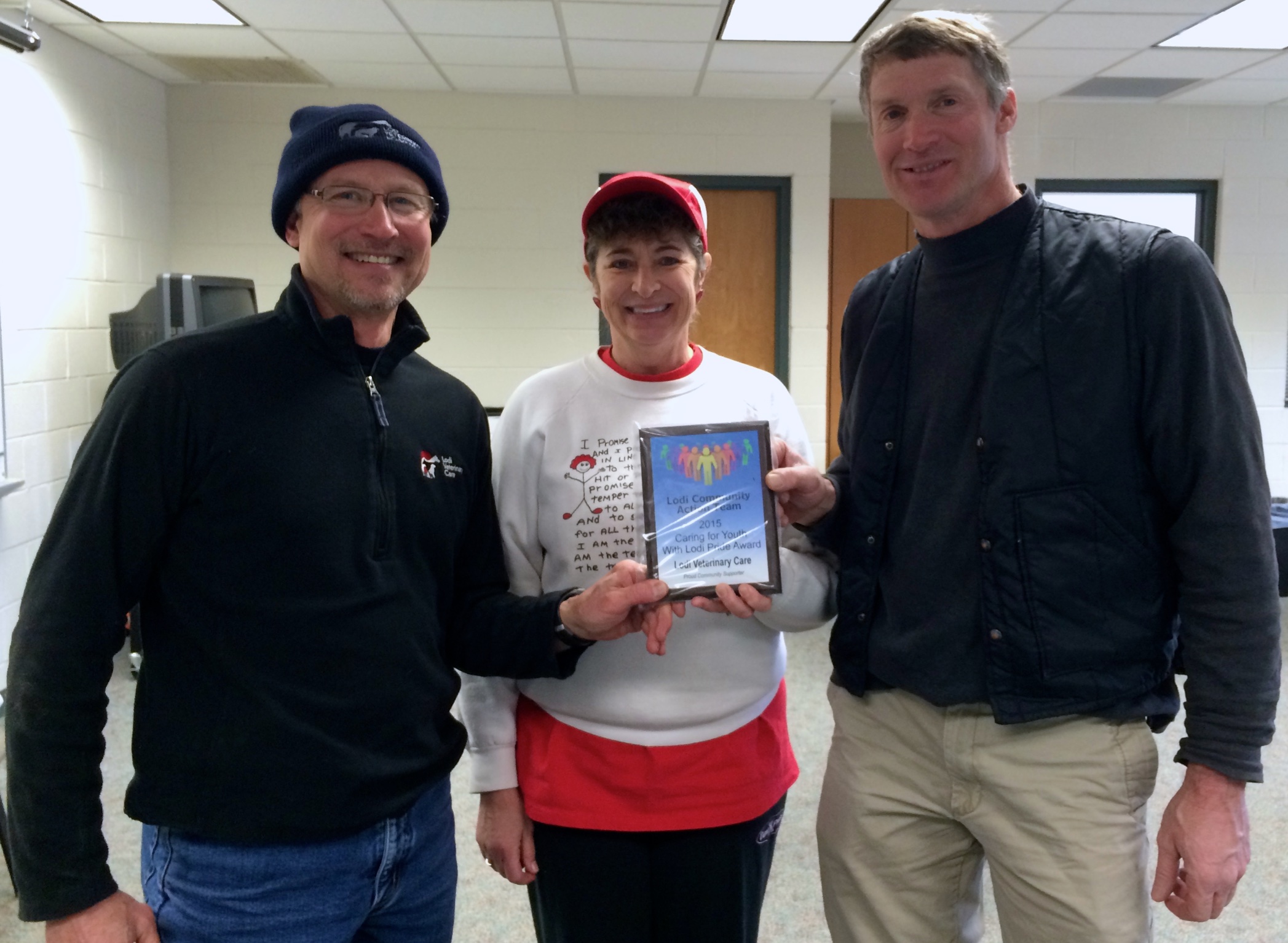 Michelle Pare (middle), retired Lodi Music Teacher, presents a Lodi Pride Award to the Lodi Veterinary Care. Pictured from the Lodi Veterinary Care are Dr. Mike Etter (left) and Dr. Bob Steiner (right).