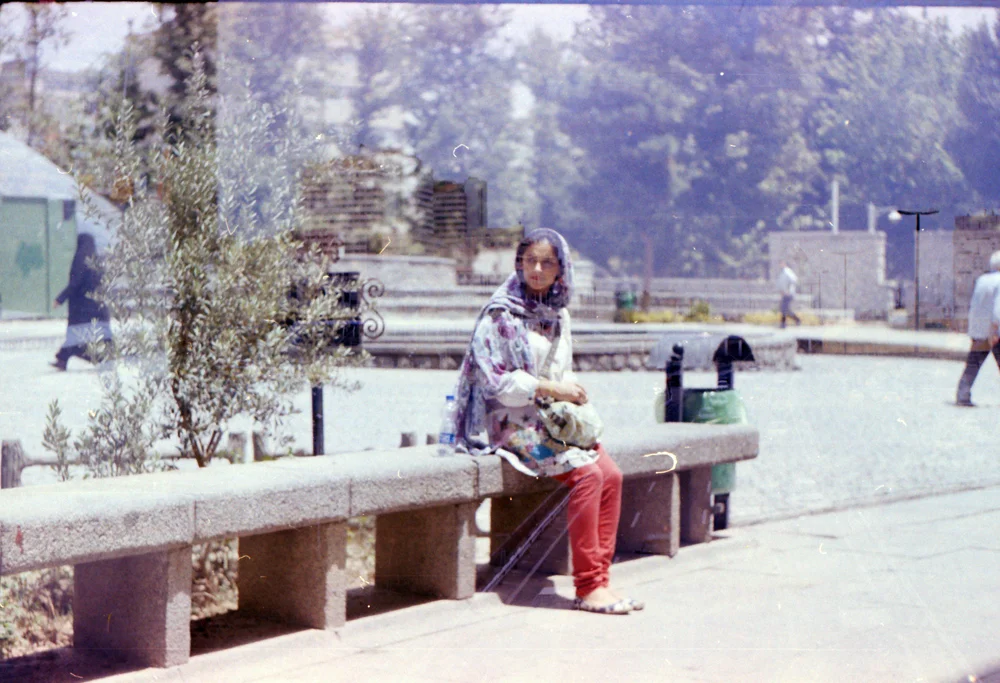 He once told me he had lost the negatives. One day before I leave, he took some photos of me, in the central part of Tehran, Meydoon Vali-Asr, Enghelab. It was a s strange day, I had so many mixed feelings; excitement, fear, feeling an absence. He found the negatives. I am holding my breath while looking at them. This is not me. I left me that day on that grey bench. As I am writing, I remember my bus ride on the way back home. Looking out the window, passing by the sad old trees of Vali-Asr, looking at their reflection on the window, the uncertainties, the grief. Those trees are far and gone, this poetic image is only an imagination. Photo by Ardalan Zandyavari