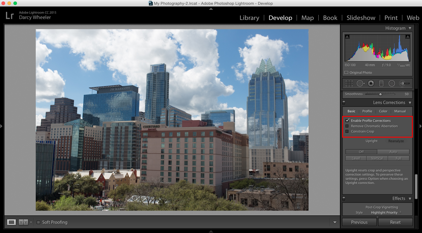 The Enable Profile Corrections feature can be found in the Develop menu in Photoshop. 