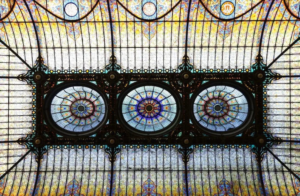 Ornate stained-glass ceiling inside Gran Hotel Ciudad de México featuring intricate patterns and circular designs