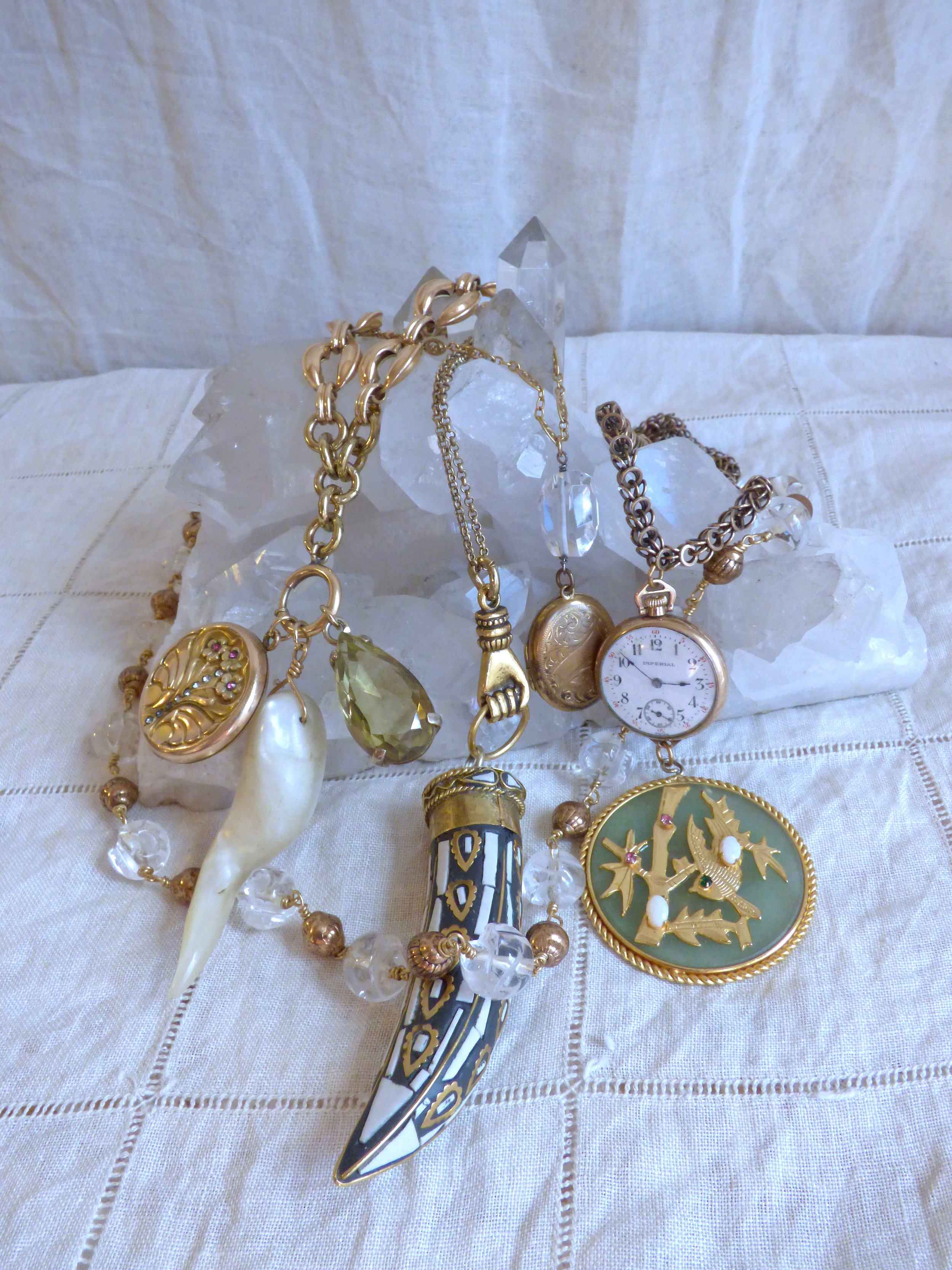  Vintage gold filled and brass charms, carved quartz skull beads, and antique gold filled chains. 