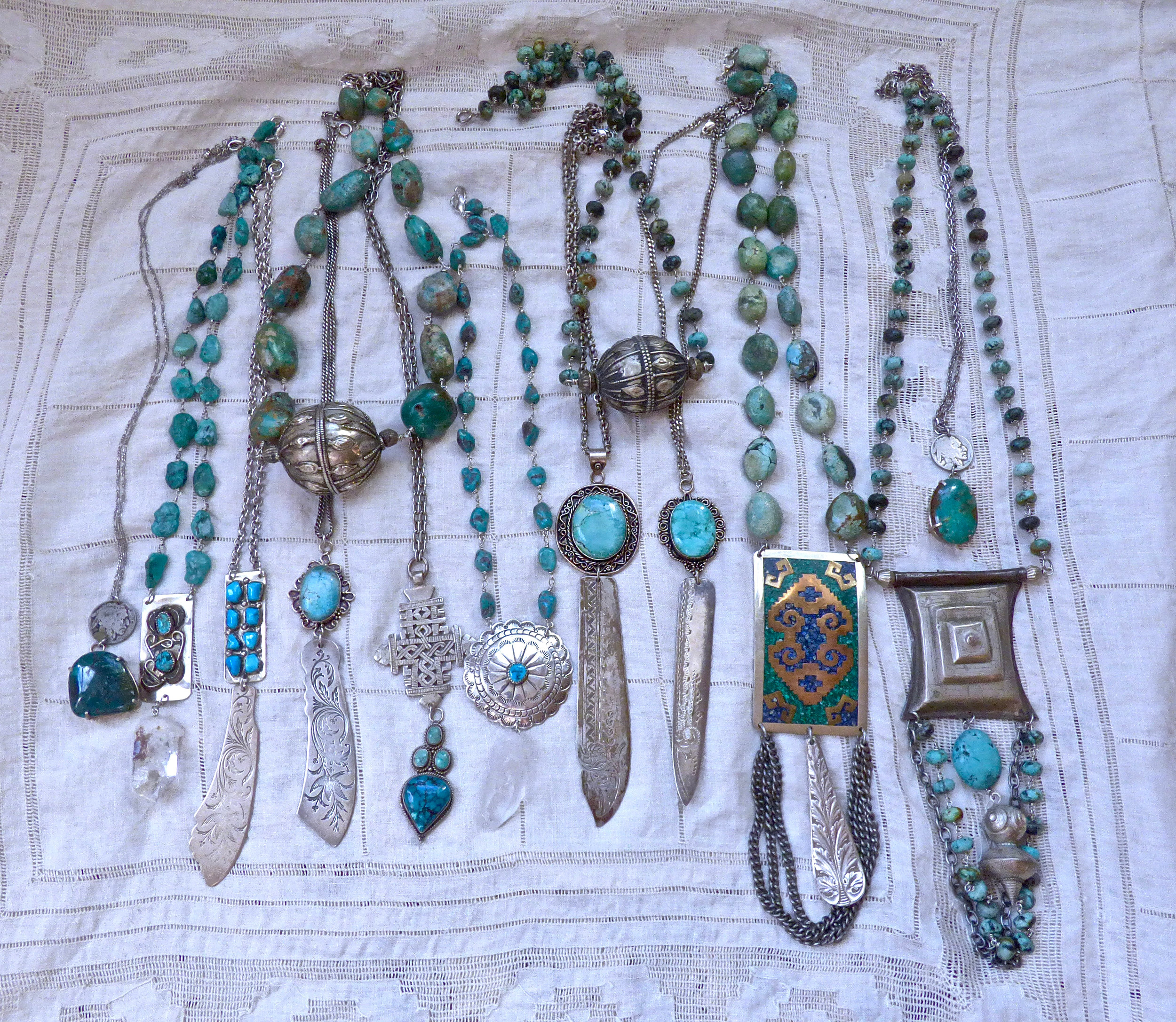  Necklaces of turquoise beads, hand set in wire, repurposed Navajo money clips and belt buckles, Edwardian engraved knives, Tuareg medallions, Bedouin and Yemenite beads, quartz and buffalo nickels. 