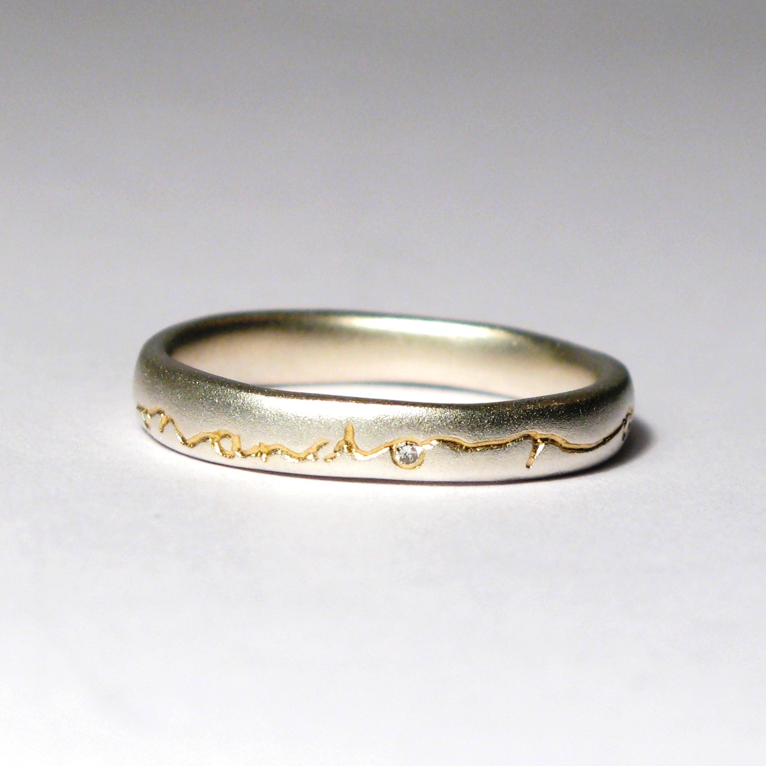 Silver ring with 22 carat gold etch and 0.01 carat diamond