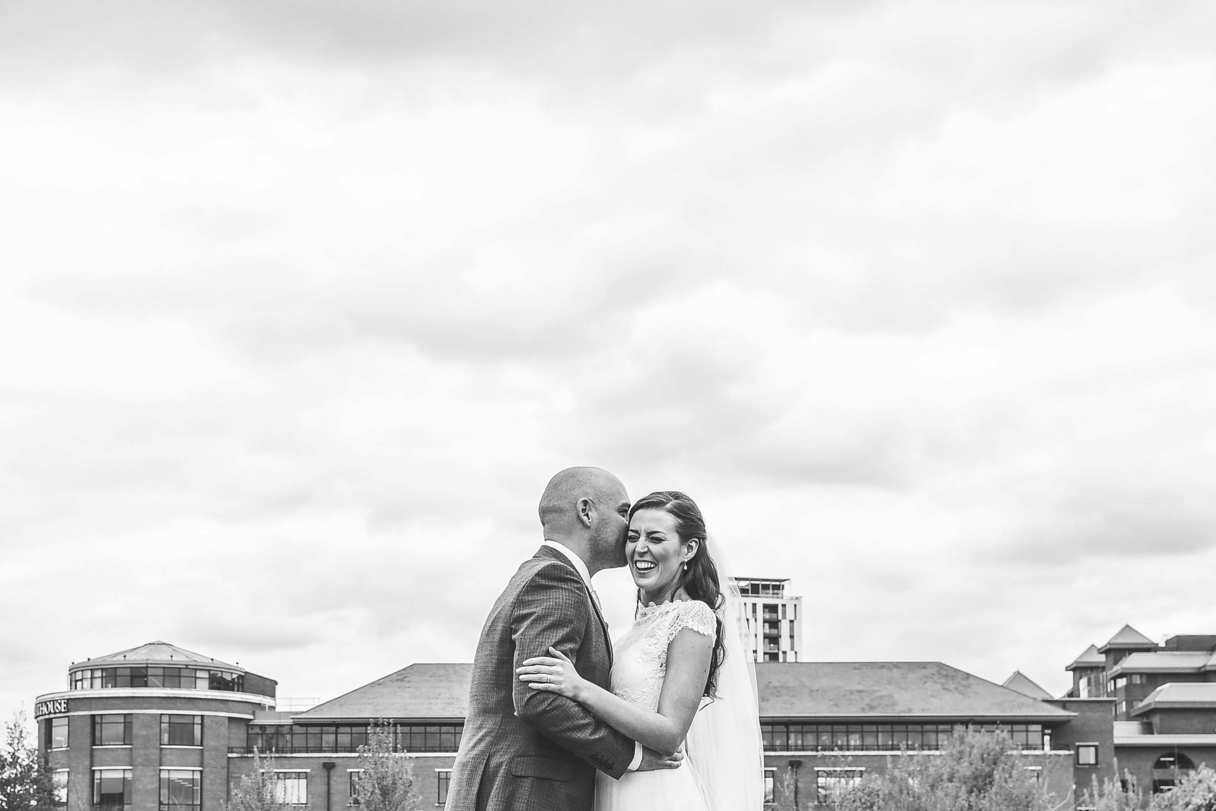 Bride and groom laughing black and white