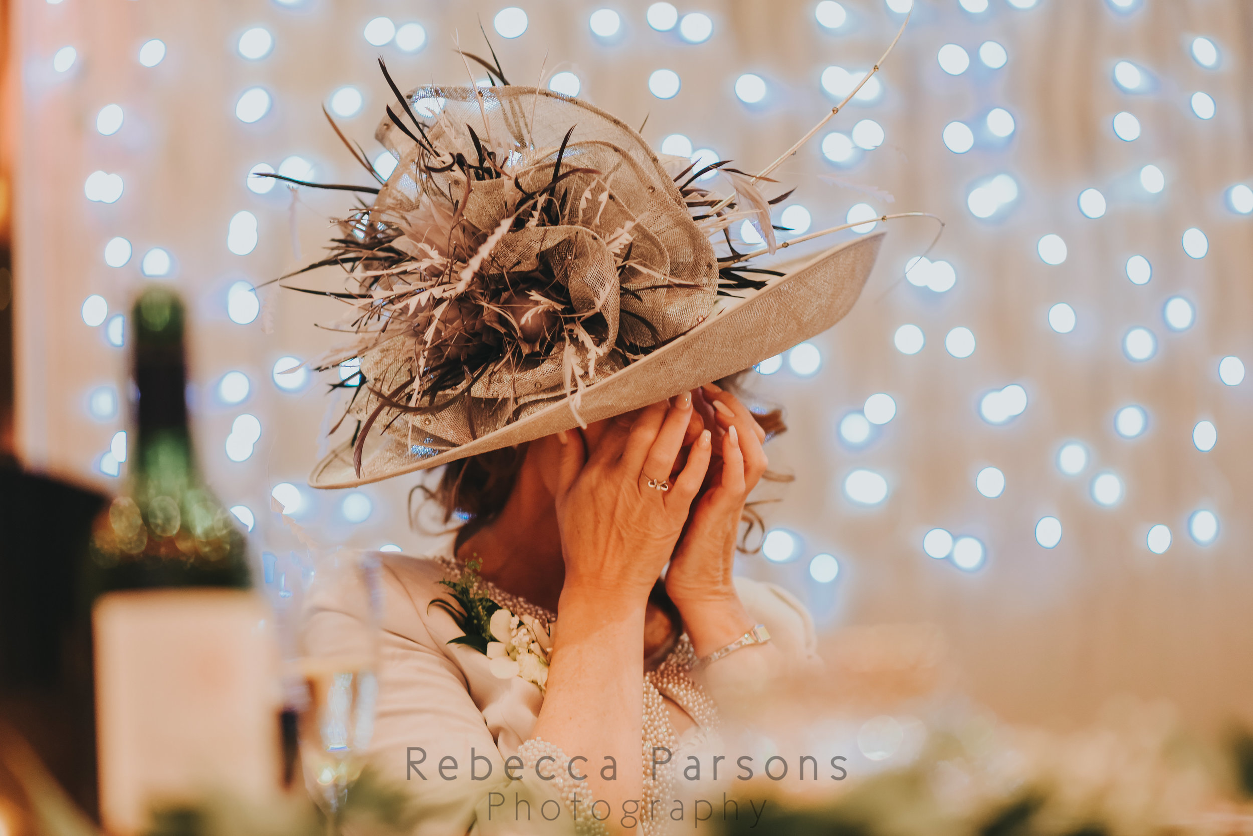 Mother of the bride covering her eyes during speeches
