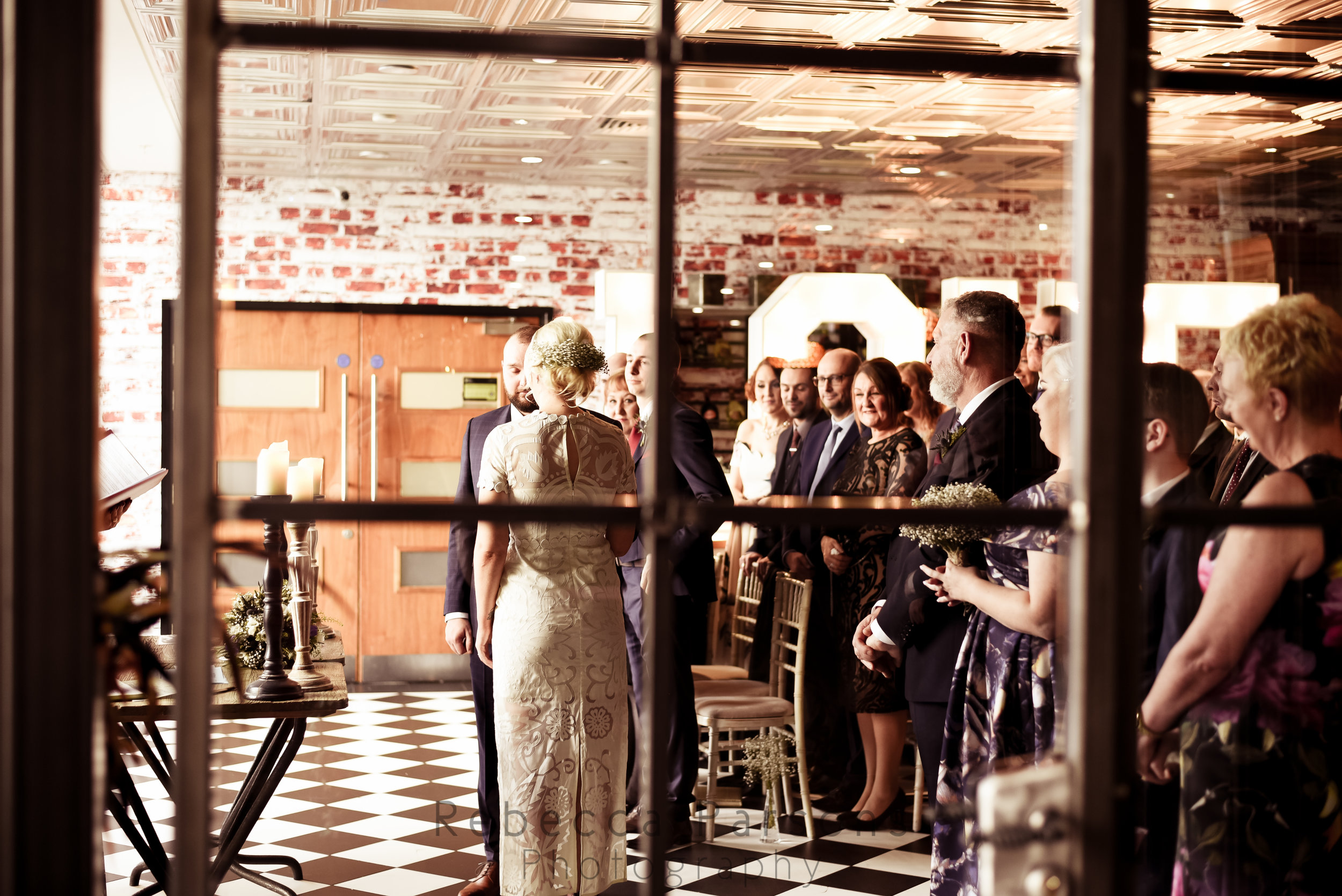 Bride and groom saying vows through doorway