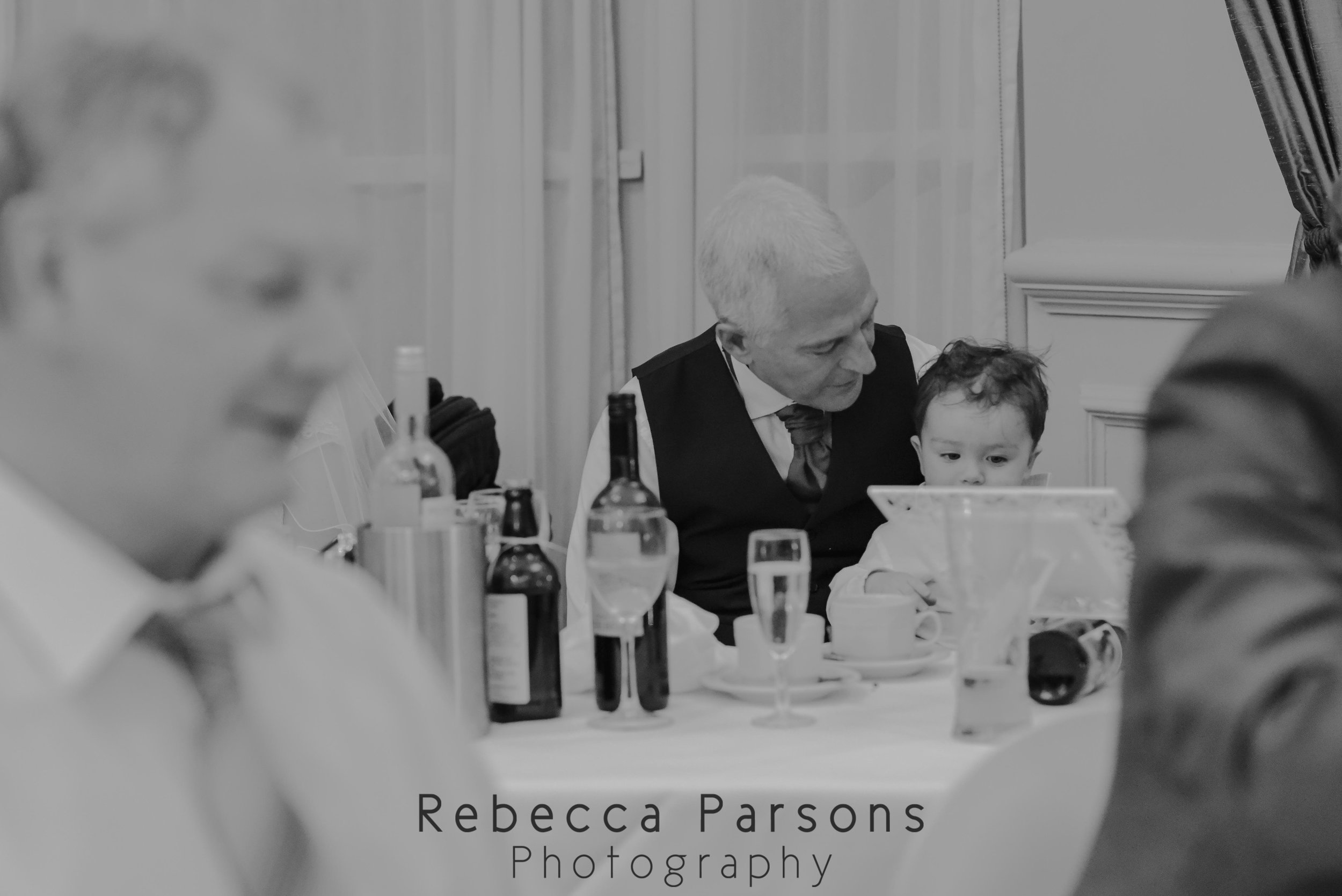 grandad and grandson at table black and white
