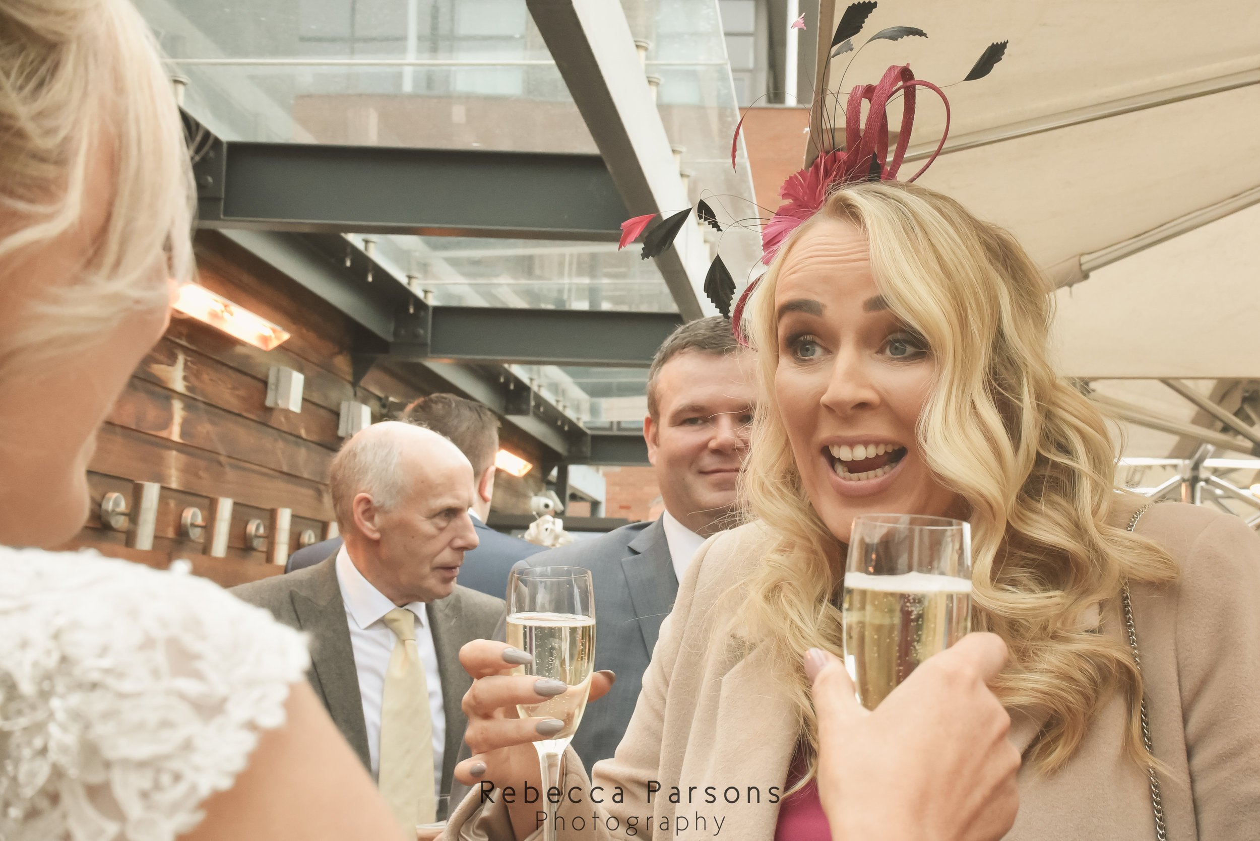 guest greeting bride with glass of wine