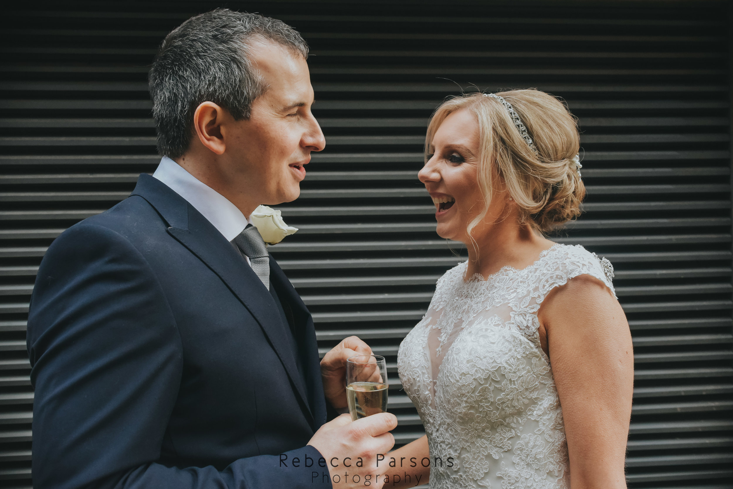 bride and groom talking on street close up