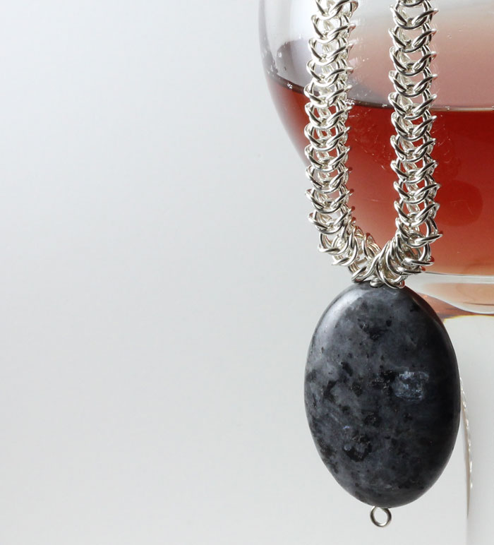 Sterling Silver Byzantine Chain with a Large Agate , presented by a glass of small-batch raspberry mead.