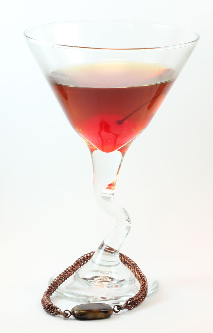 Copper Persian Bracelet with Tigerseye Bead. Shown with a large Manhattan.