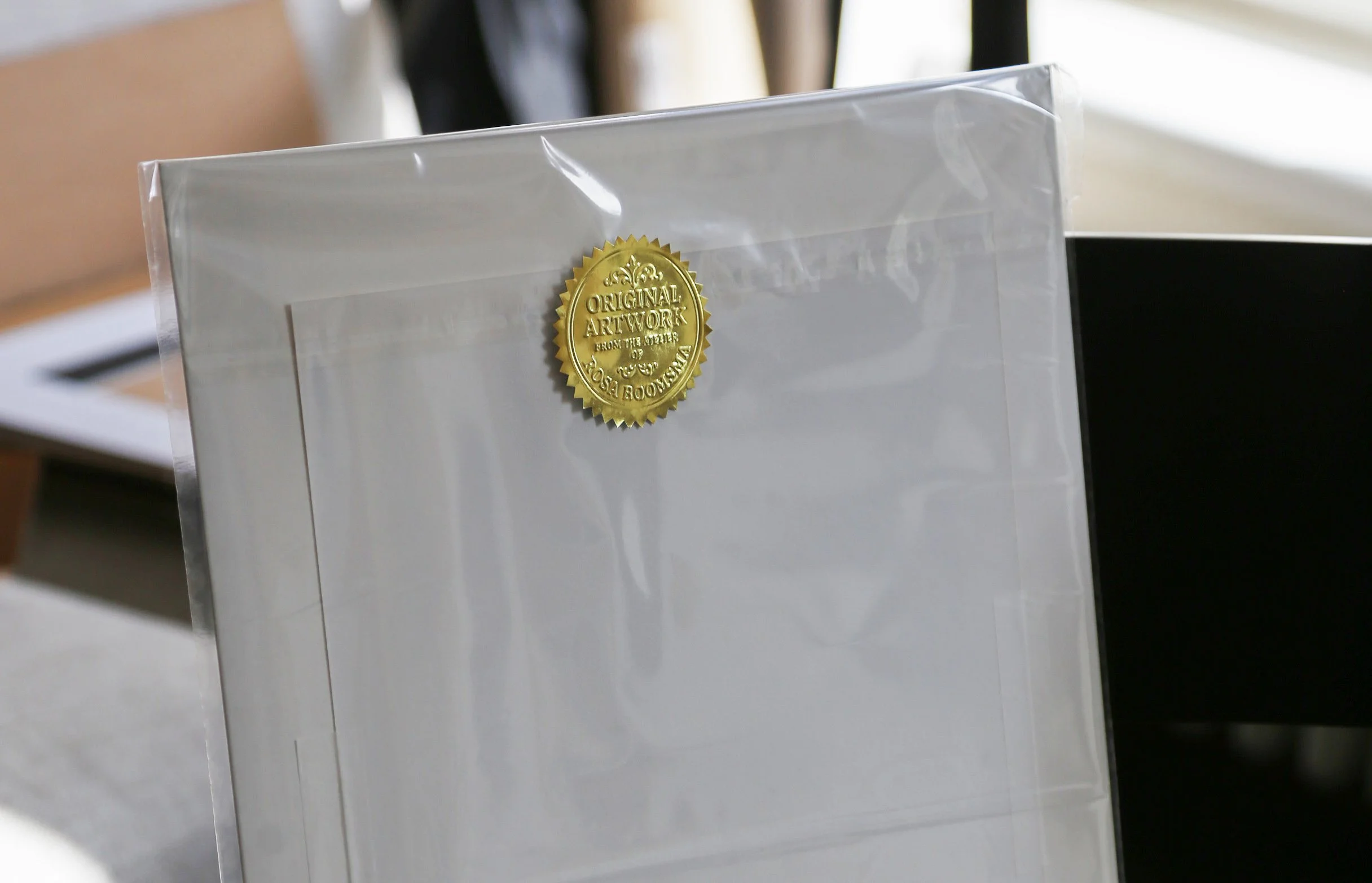 Huisportret als cadeau ingepakt met zegel van de kunstenaar