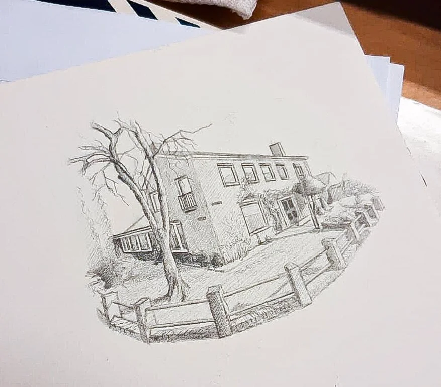 Een getekend huisportret op papier