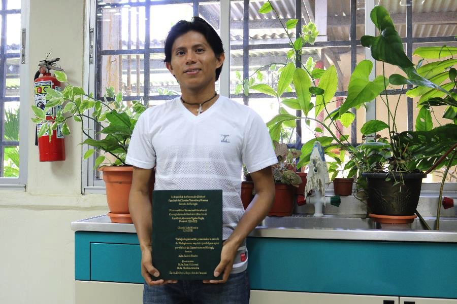 After sharing his life story, Olmedo stood for a portrait in the lab where he completed his undergraduate thesis. He is currently working on his Masters in Biology.