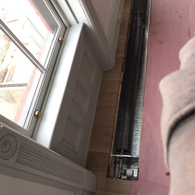 Work in progress- solving heating issues. Original contractor installed in-floor heating units that were too small to provide adequate heat to the space, had no proper control, and no space for convection. Check out the before picture of the radiator