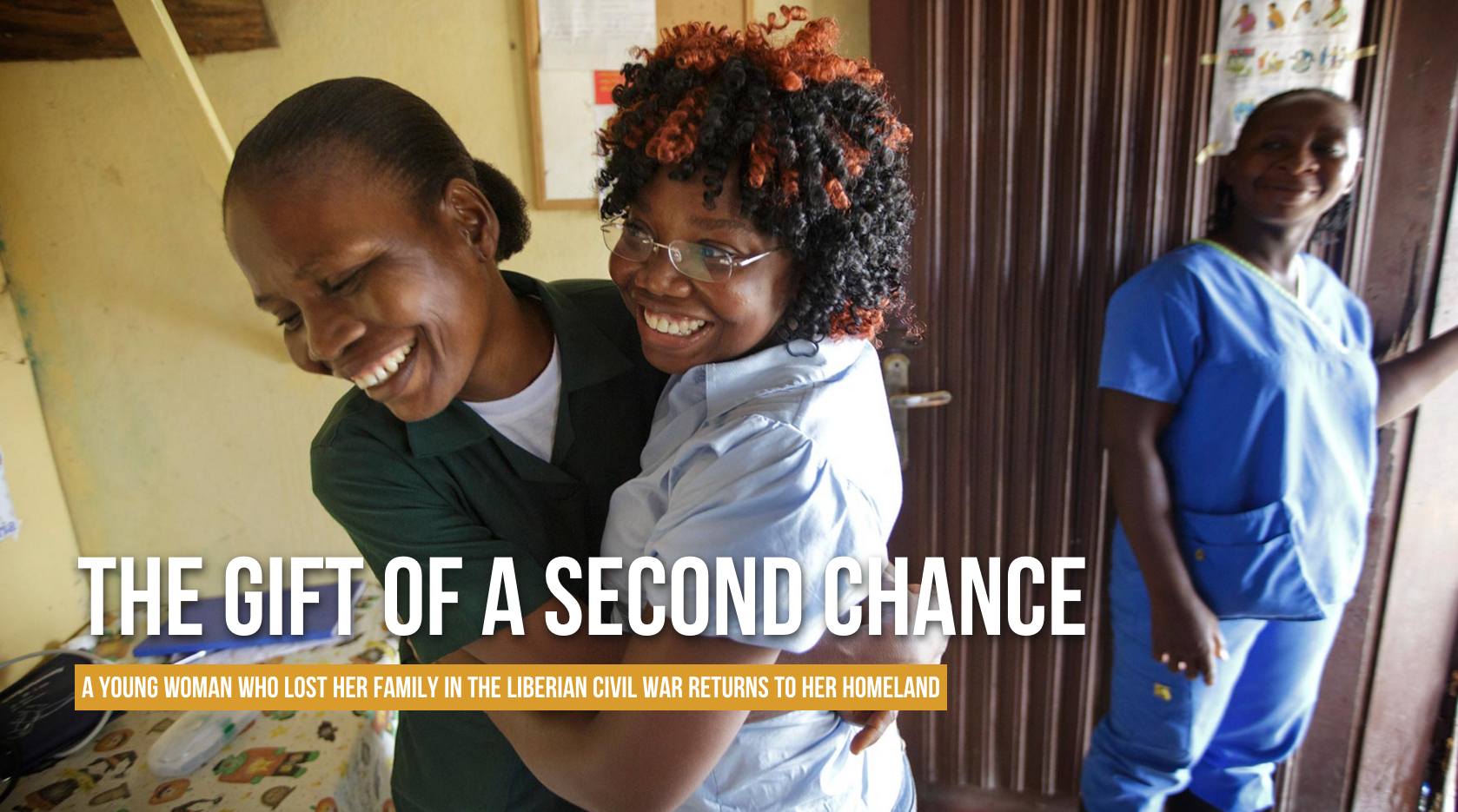 Gift Bender, center, embraces a former staffer at the Monrovia, Liberia, foster home where she stayed before she was adopted to the U.S., June 2, 2016.