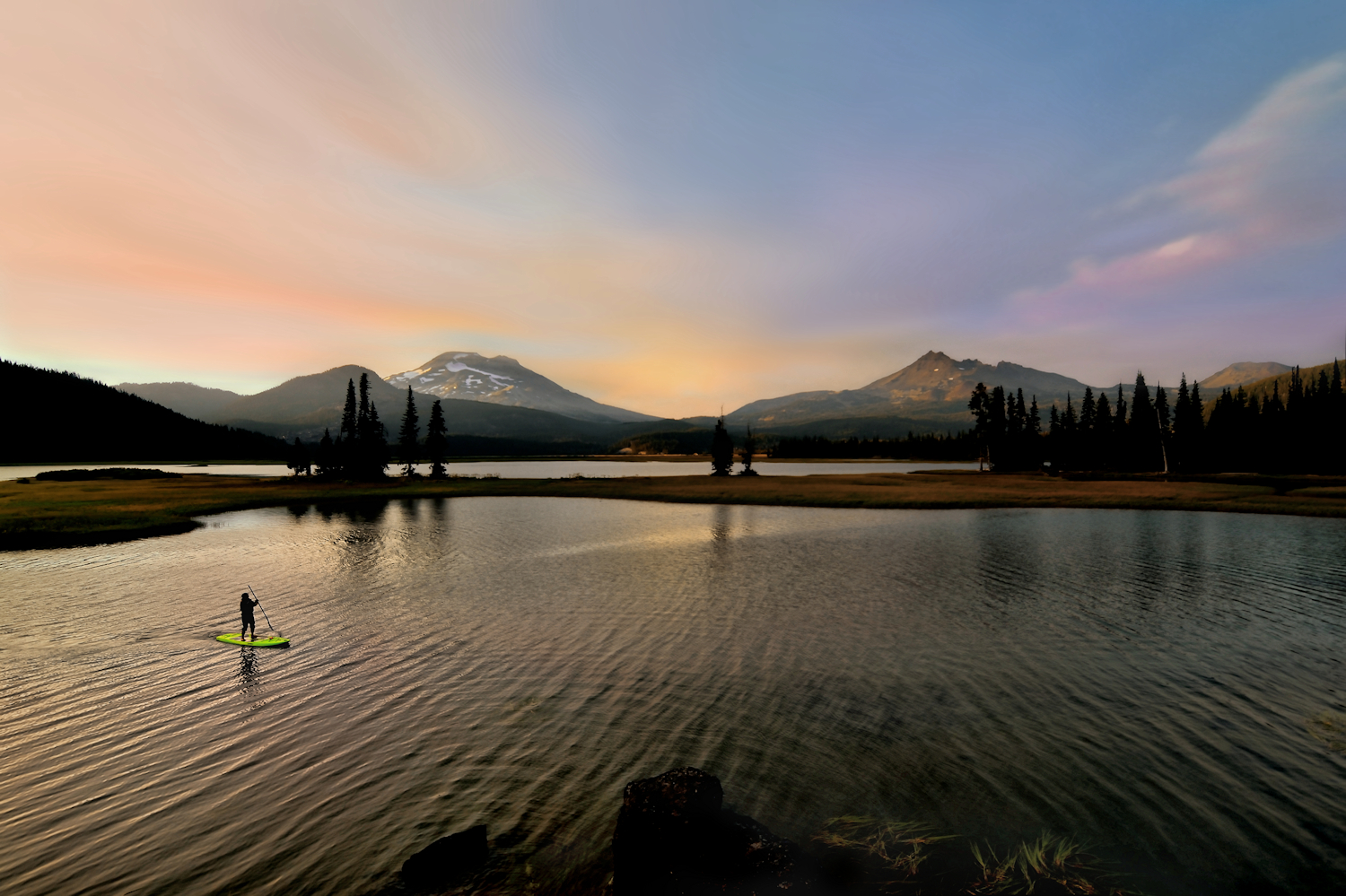 A paddle boarder on Sparks Lake in Central Oregon. Purchase Options