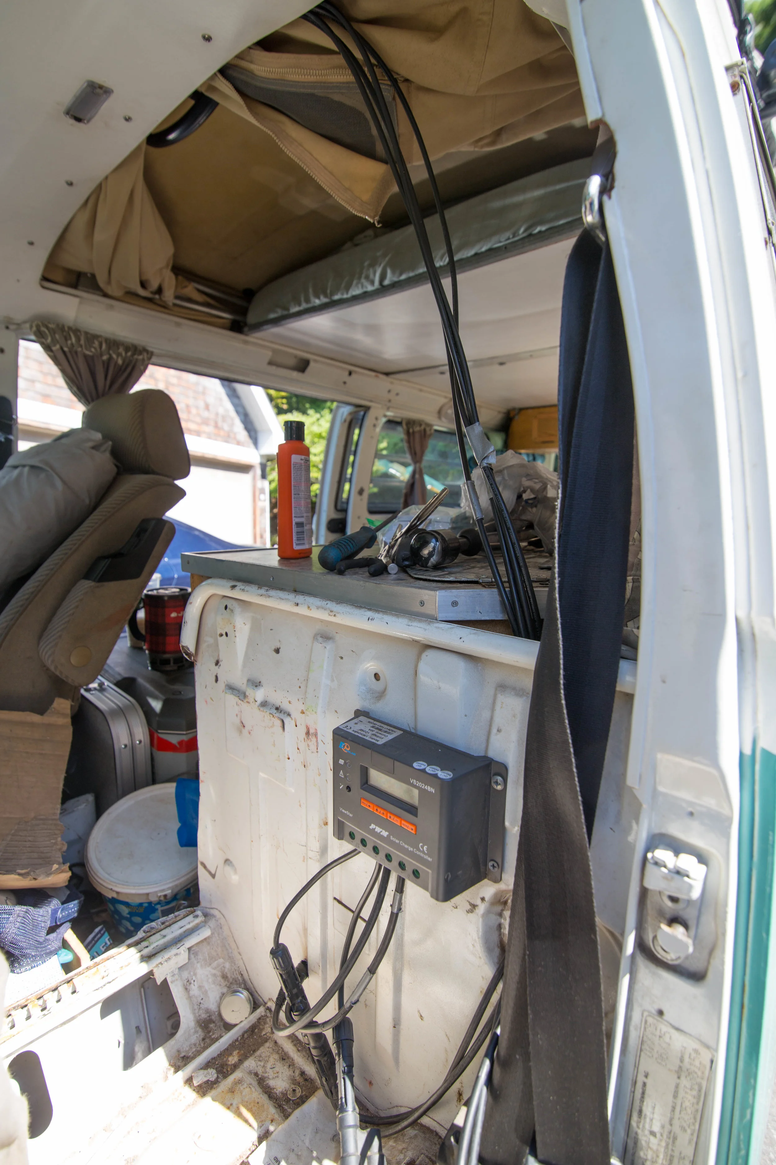 The wires are pulled from behind the headliner, secured near the driver's seat belt, then routed behind the bulkhead. I drilled a two holes in the bulkhead, one for the panel wires to the controller and one for the tray wires, from the controller to…
