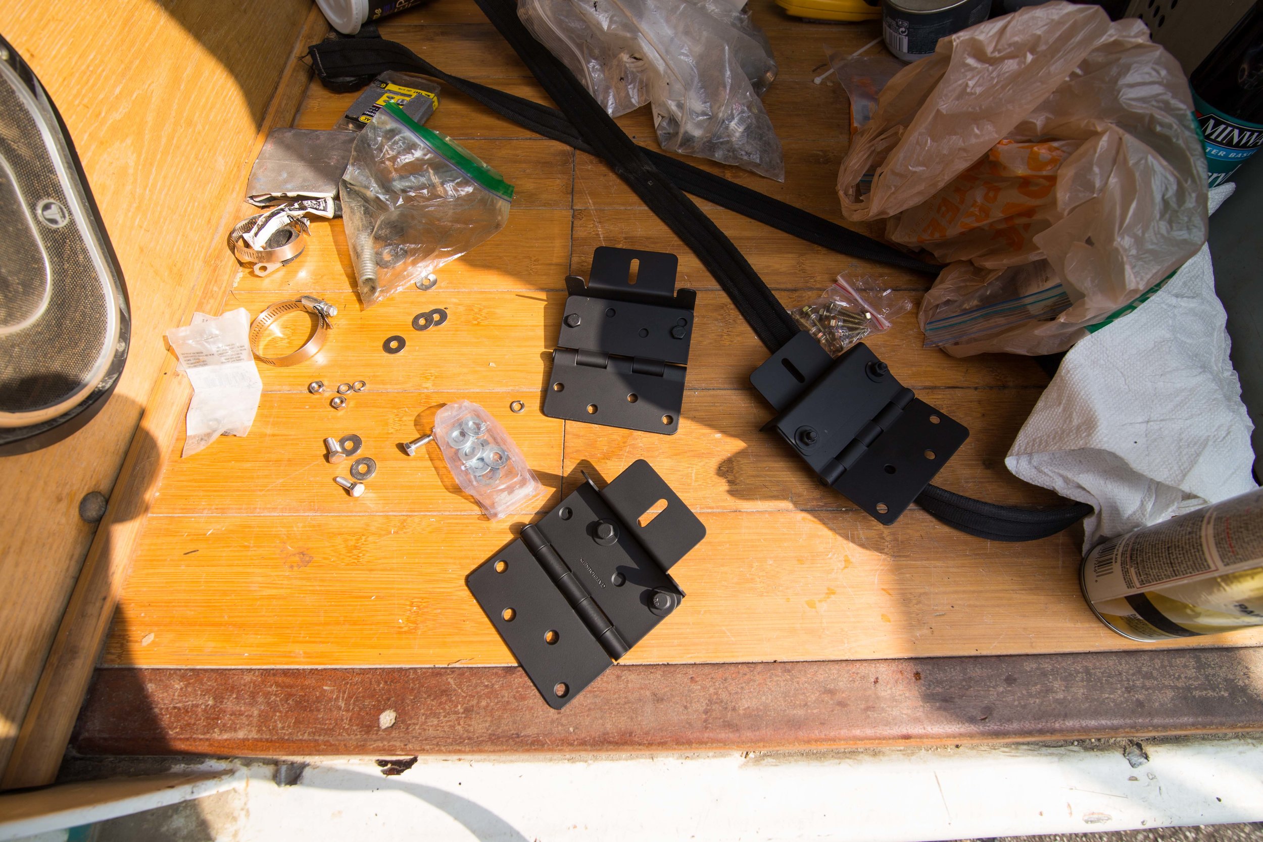 Once you have the holes drilled mount the hardware to join the two. I spray painted everything black for a cleaner look that matches the black edges of the solar panels. The mounting brackets come in a silver finish, and the hinges come in an assortment of finishes.