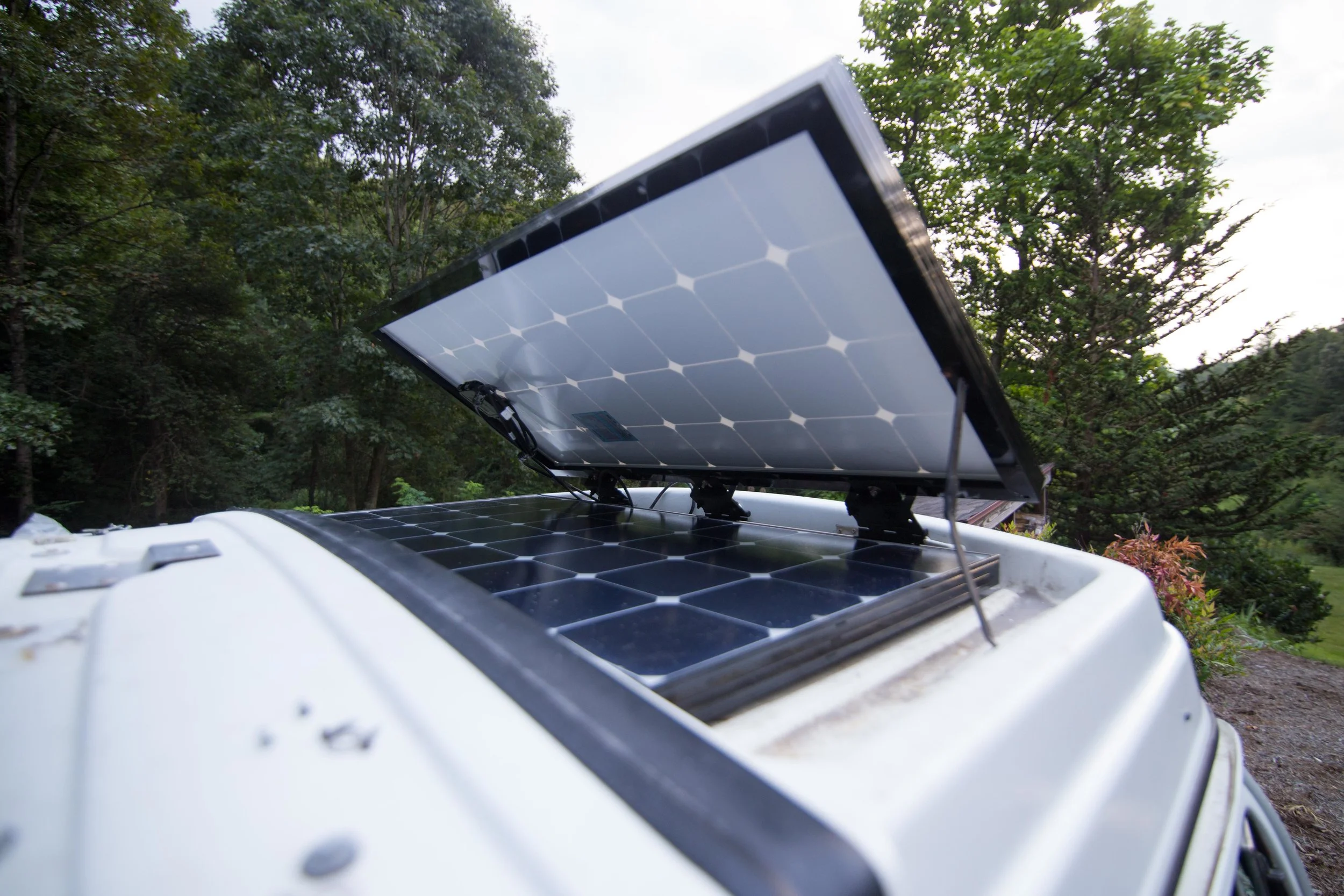 I drilled two holes in the side of the panel once test fitting the lid support and the angel it would create. I mounted it, and then bent the lid support outward so it sits securely in one of the luggage rack tie downs. With this mounting system the…