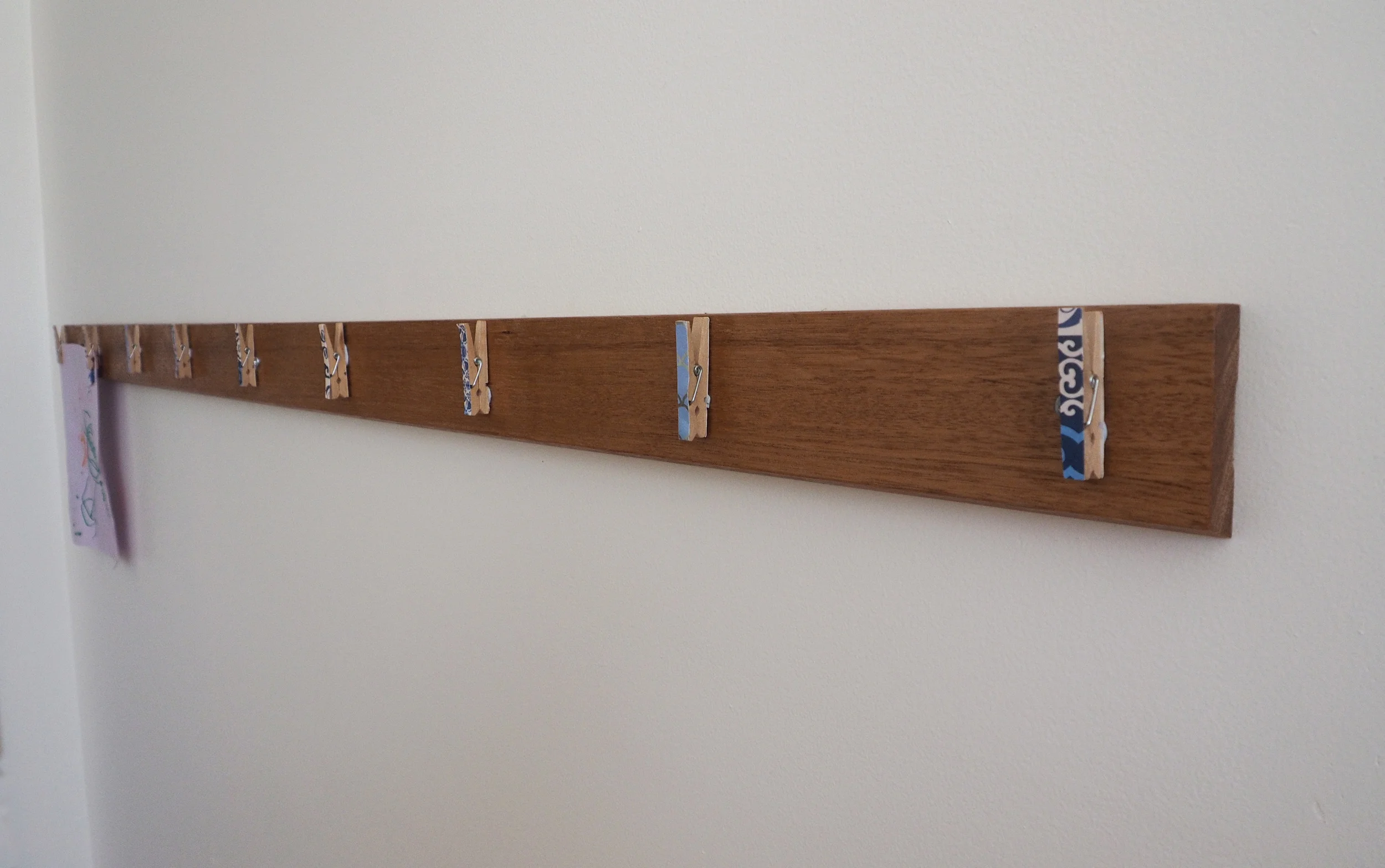 attaching pegs to the art display wall