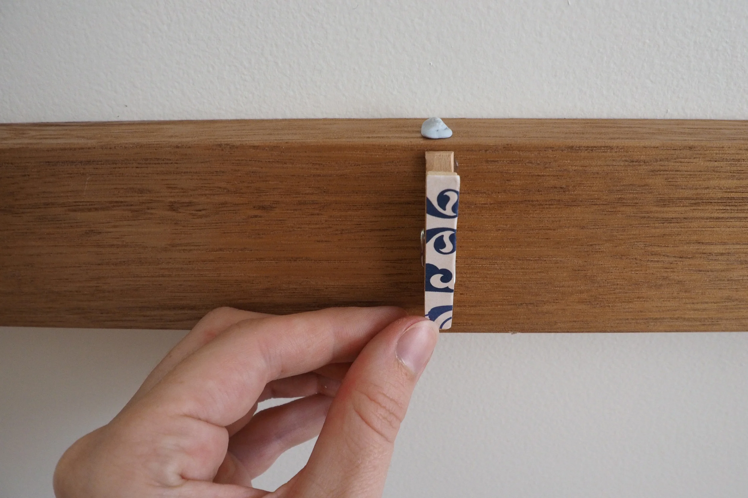 Creating a child's artwork display with pegs and hot-glue gun