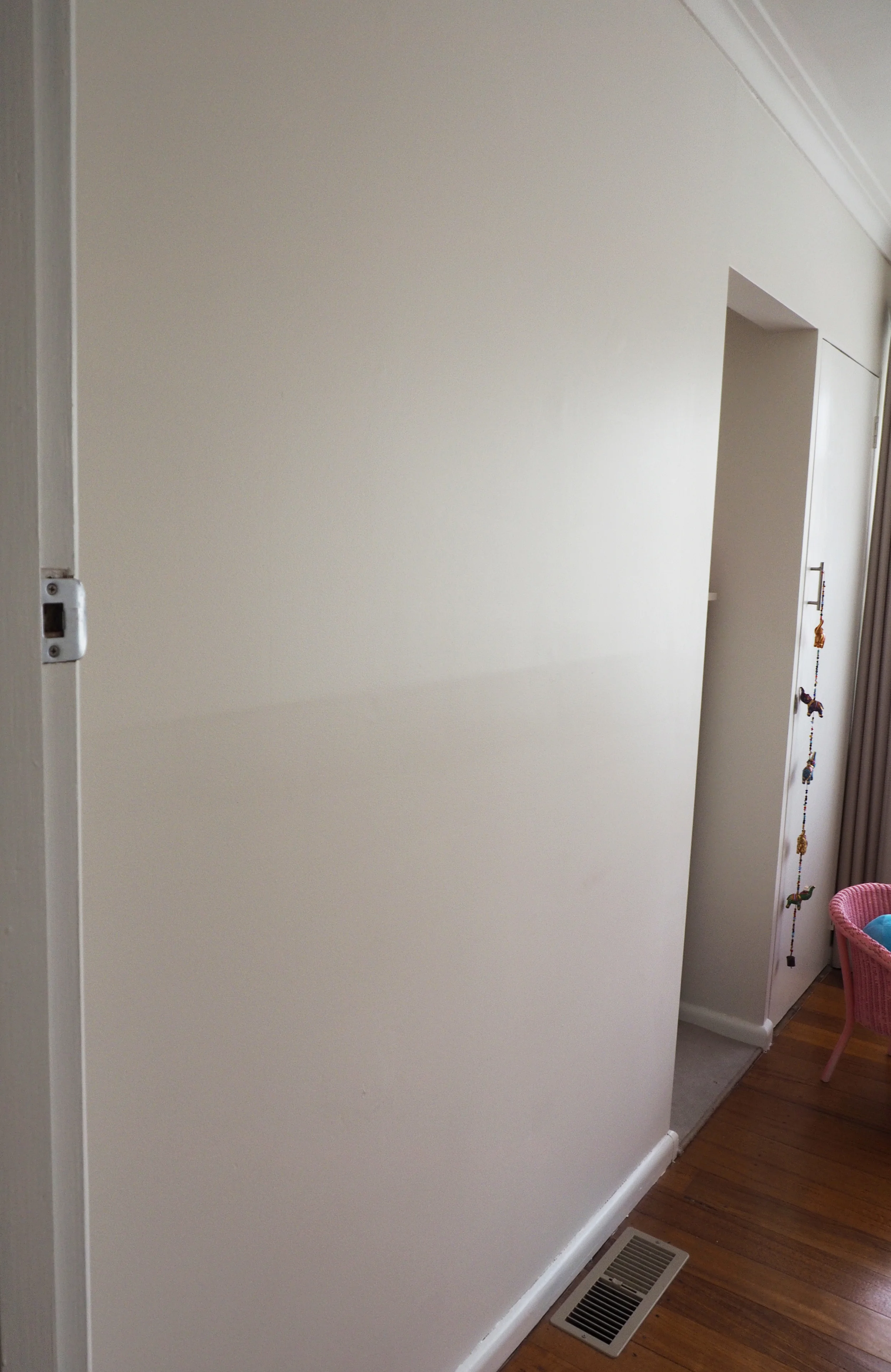 A blank wall in the bedroom is the perfect spot for creating a child's artwork display
