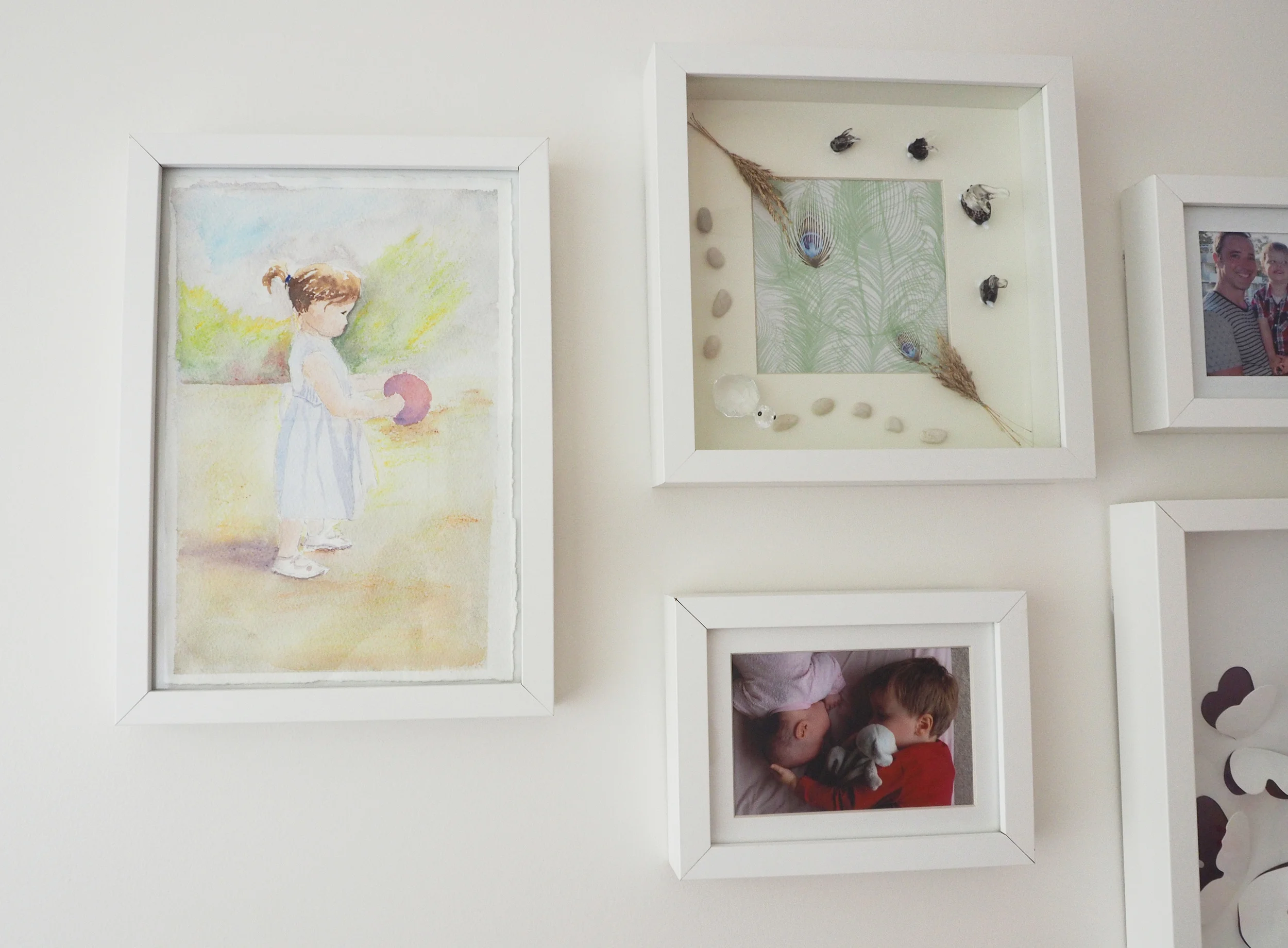 Photo gallery wall - beautiful paintings and photos to add visual interest to a child's bedroom