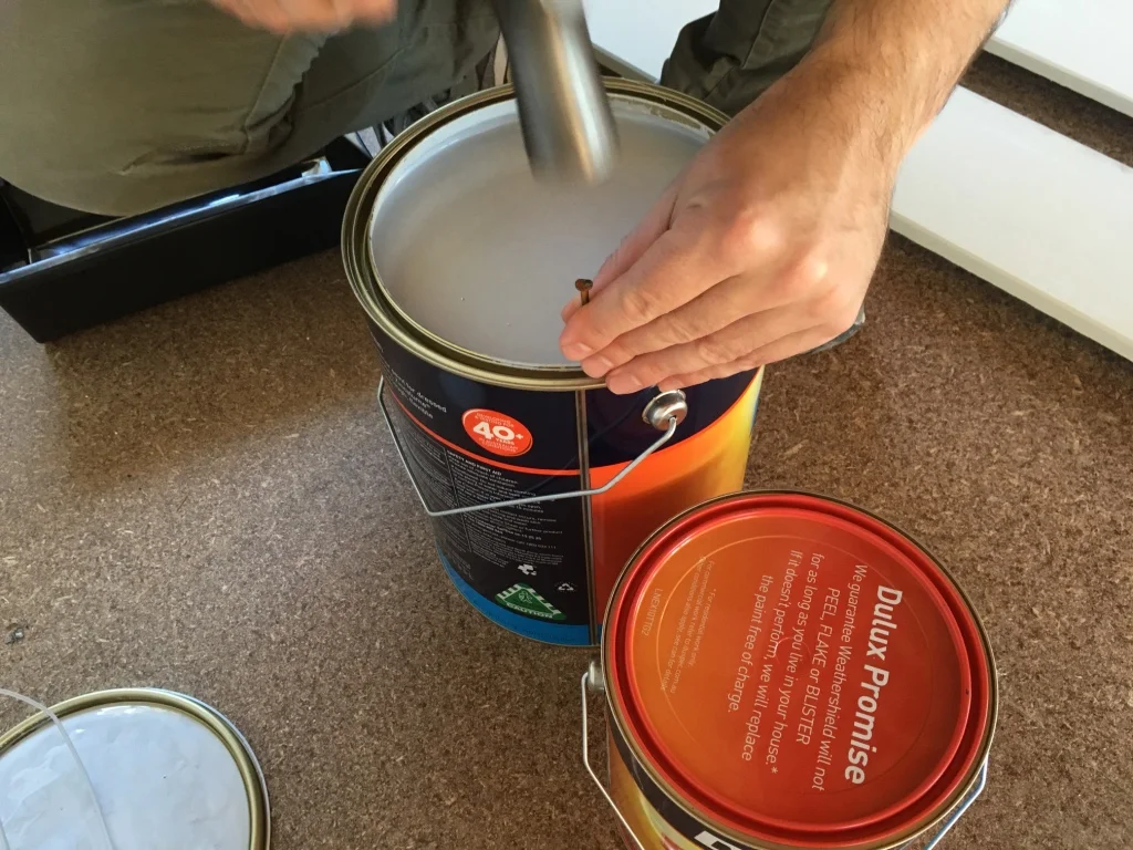 Nailing holes in the rim of the can will prevent puddles forming in the rim when pouring