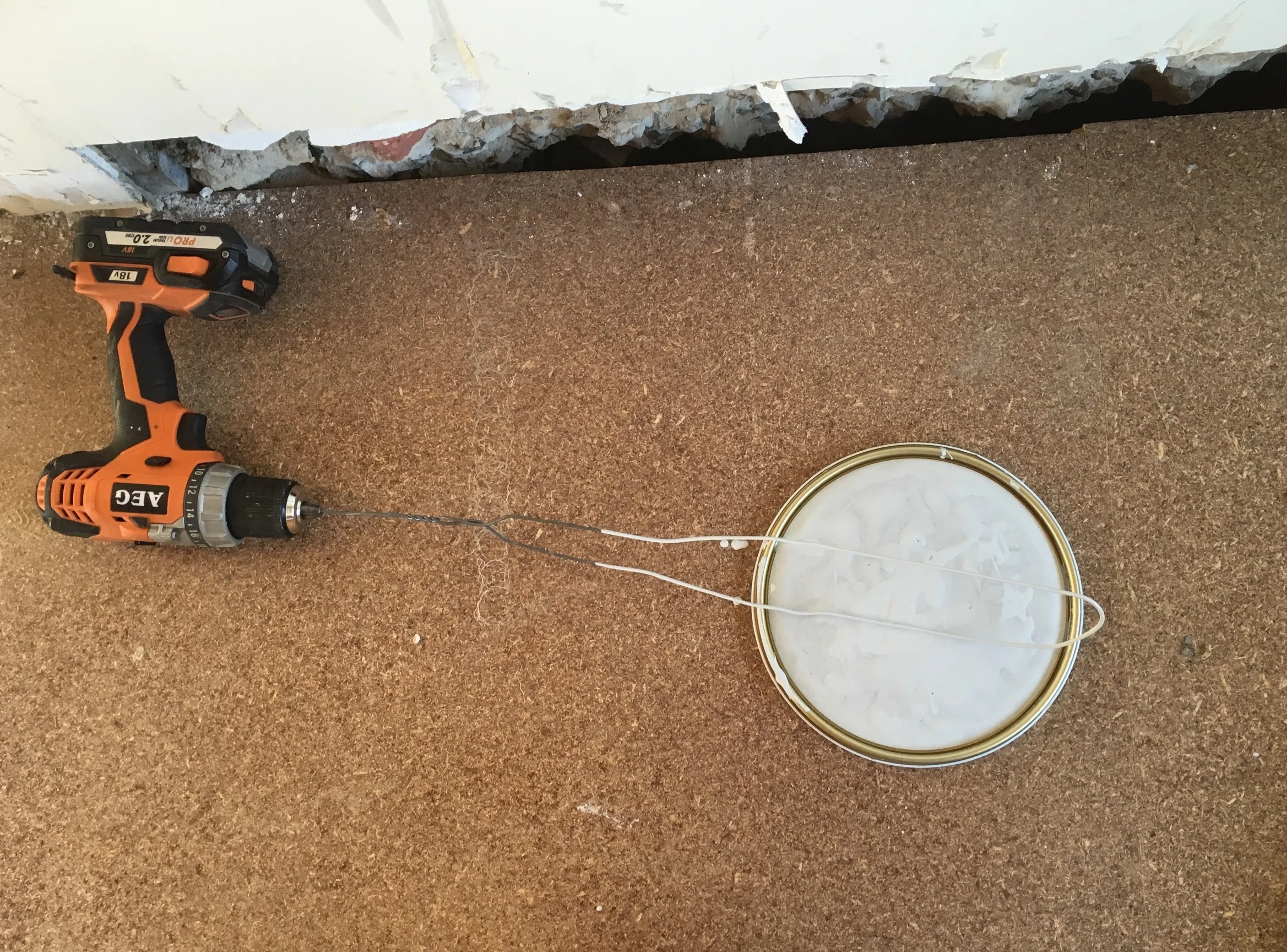 Attach a wire coathanger to a drill to quickly and thoroughly mix the paint