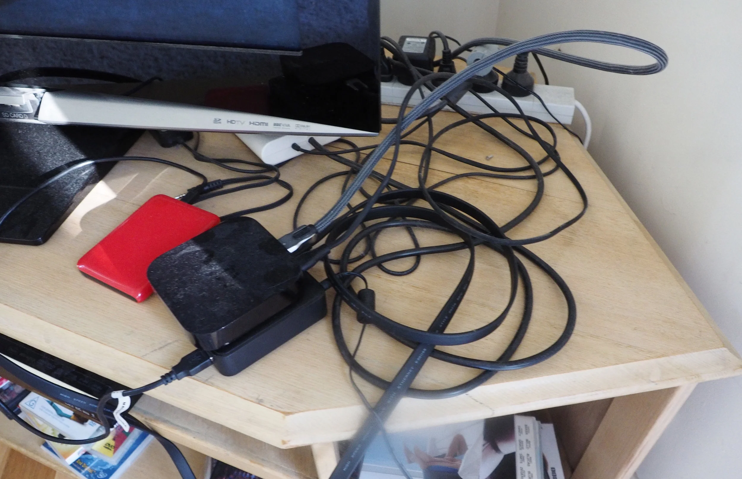 Does this cord clutter on the TV unit look familiar to you? Learn how to fix it with these simple strategies for organising cords, click through to read! {The Organised You}