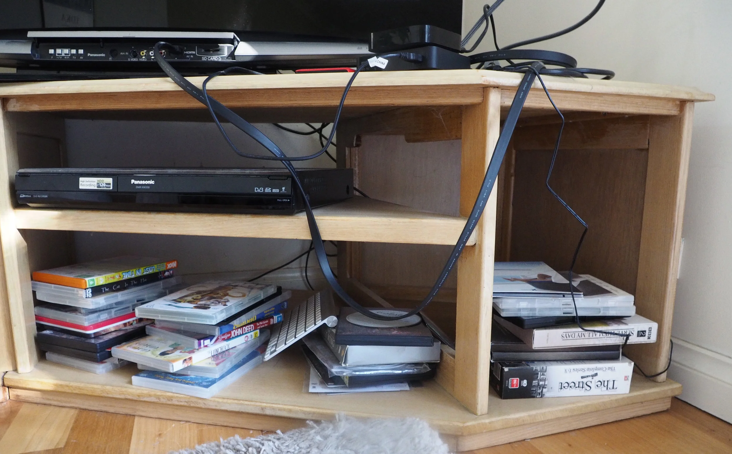 Does this cord clutter on the TV unit look familiar to you? Learn how to fix it with these simple strategies for organising cords, click through to read! {The Organised You}