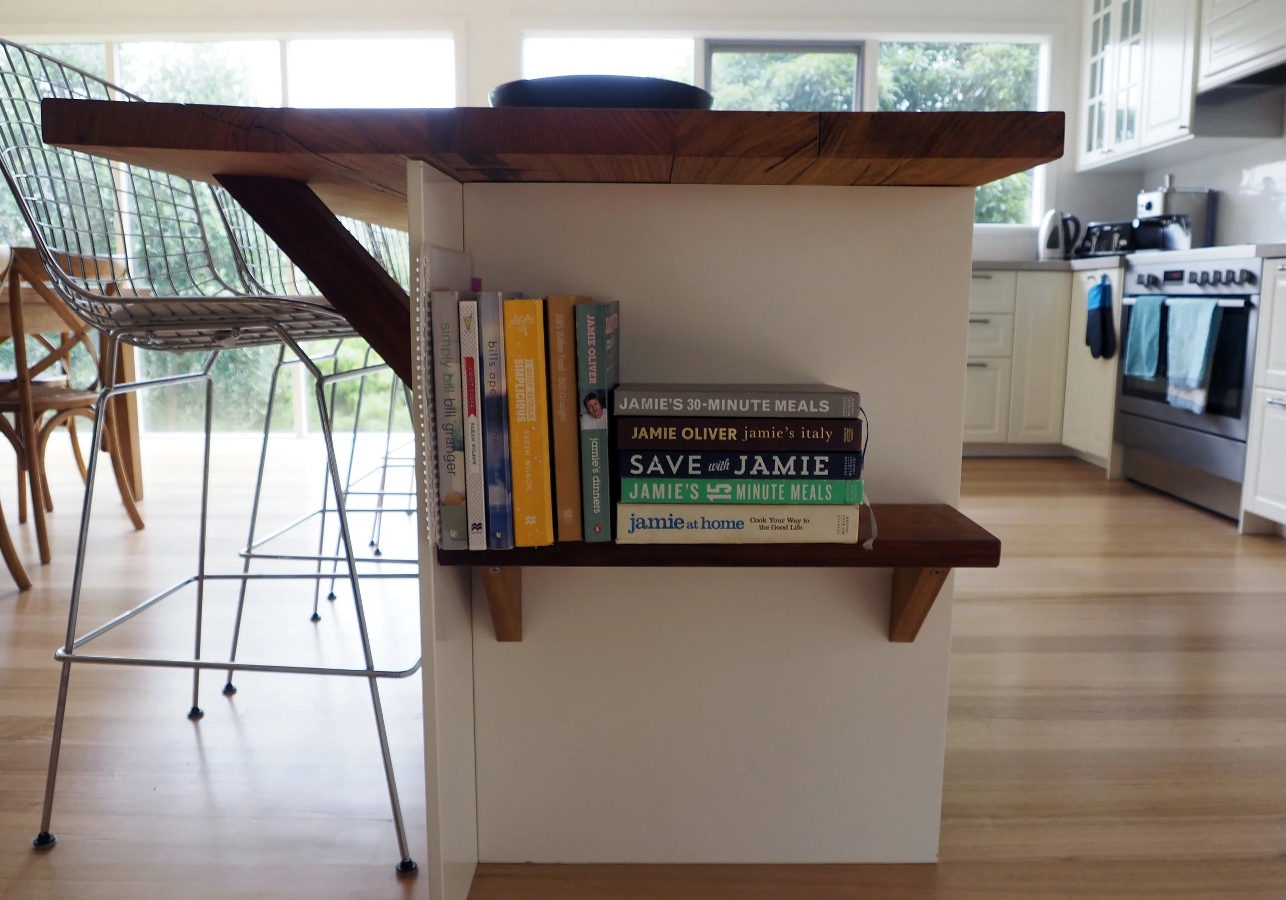Use the empty space under your island bench as a clever storage solution for recipe books {The Organised You}