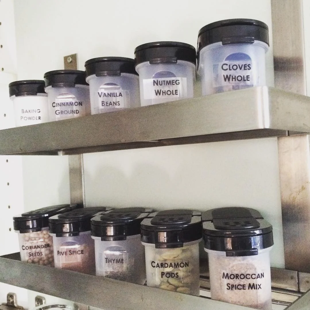 Use the back of a cabinet door as storage for a spice rack