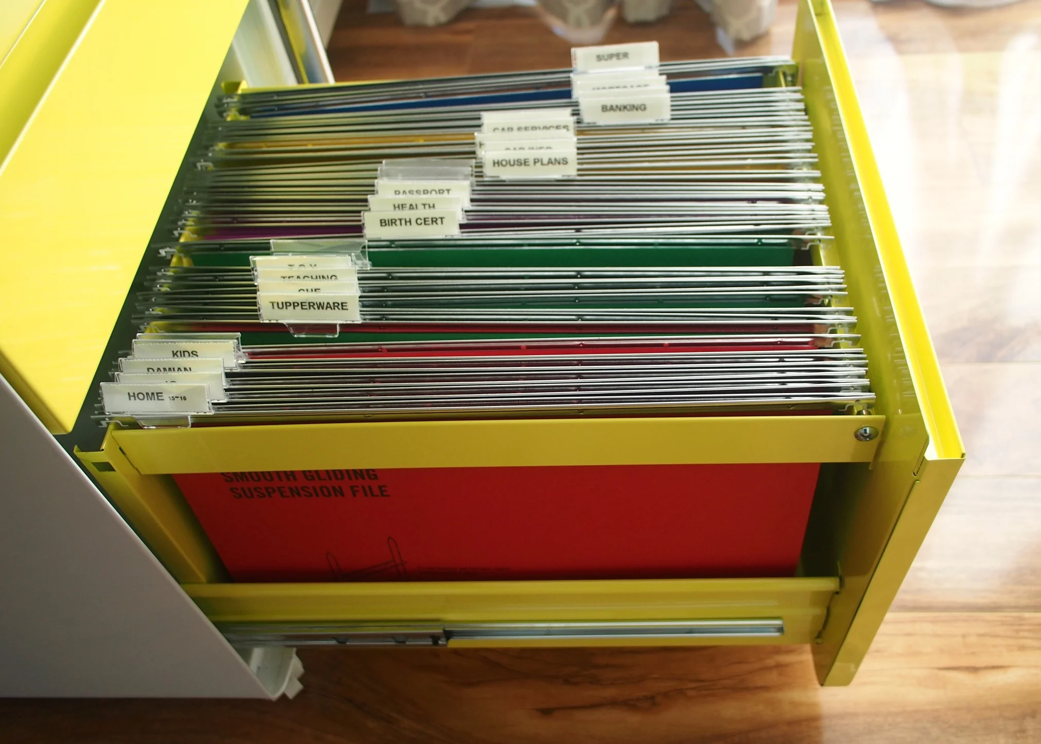 Sort the paperwork you need to keep in a filing cabinet with coloured file folders {The Organised You}