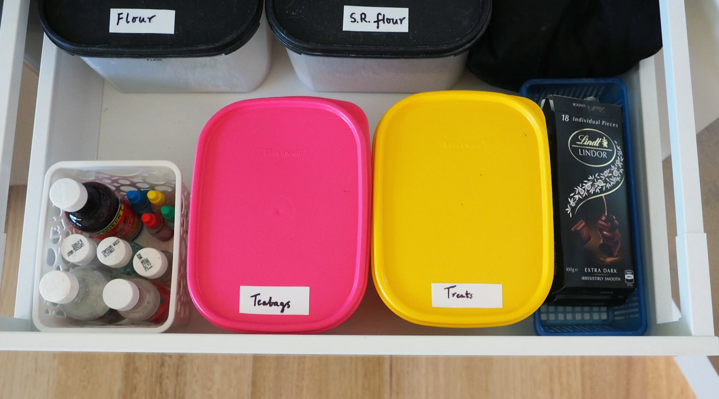 Organise loose containers in a pantry using a small basket