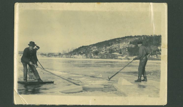 Ice blocks, once scored and cut, are floated down a track to the ice house for storage. 