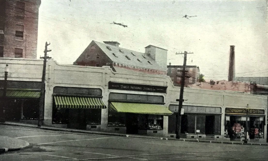 Ca. 1940 view of the Main and Friend Street storefronts. A portion of Mill 8 is visible in the upper left.
