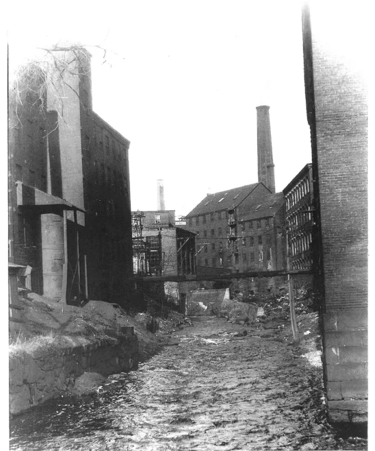 Looking up the Powow River from the lower millyard, about 1920. (Courtesy of Amesbury Public Library.)