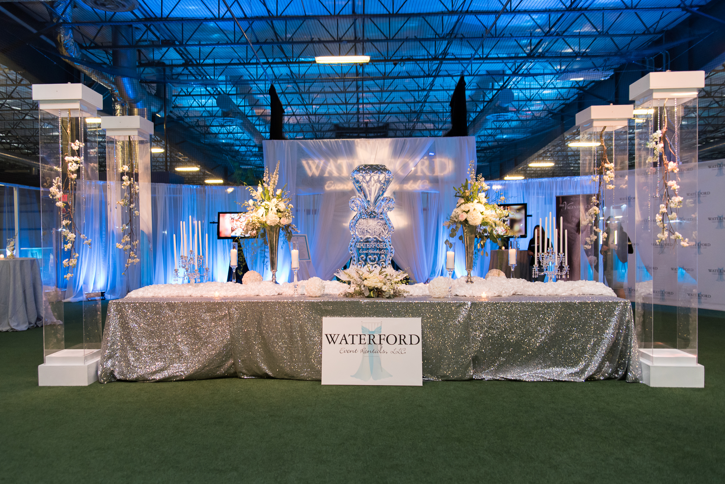 Design and linens by Waterford Event Rentals. Florals and columns by Botanique. Ice sculpture by Ice Art. Uplighting by Blue Steel Lighting Design.