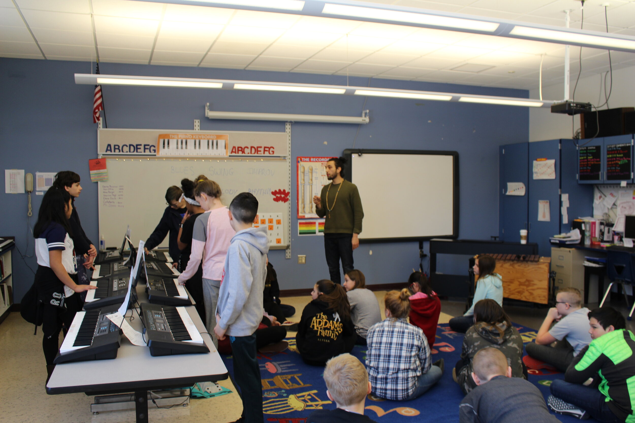 Students improvise to the blues on keyboards with pianist Mathis Picard.JPG