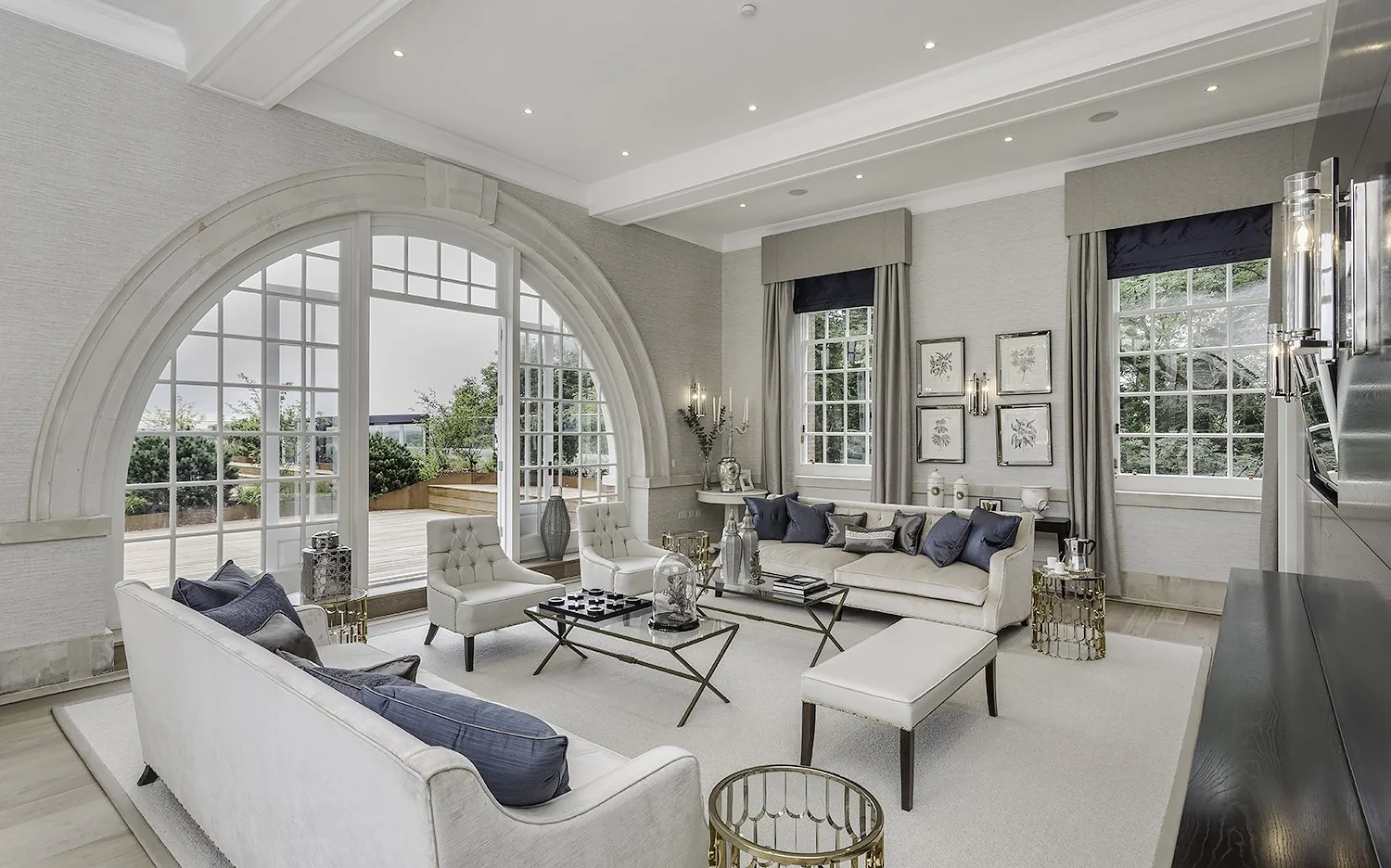 The luxury apartment combines elegance and practicality with high-quality finishes and smart design. The open living area has large windows that bring in natural light and offer great views. Custom furniture made from rich woods and fine fabrics add