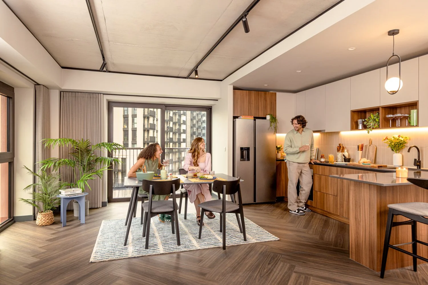  Friends enjoy food and drink in their new apartment.  