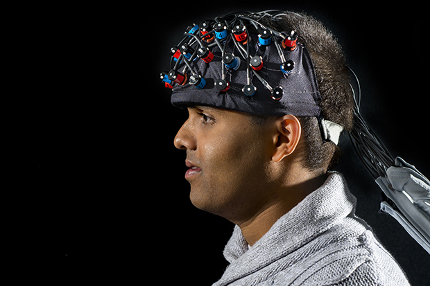 Danushka Bandara G’12 wears the functional near-infrared spectroscopy device.