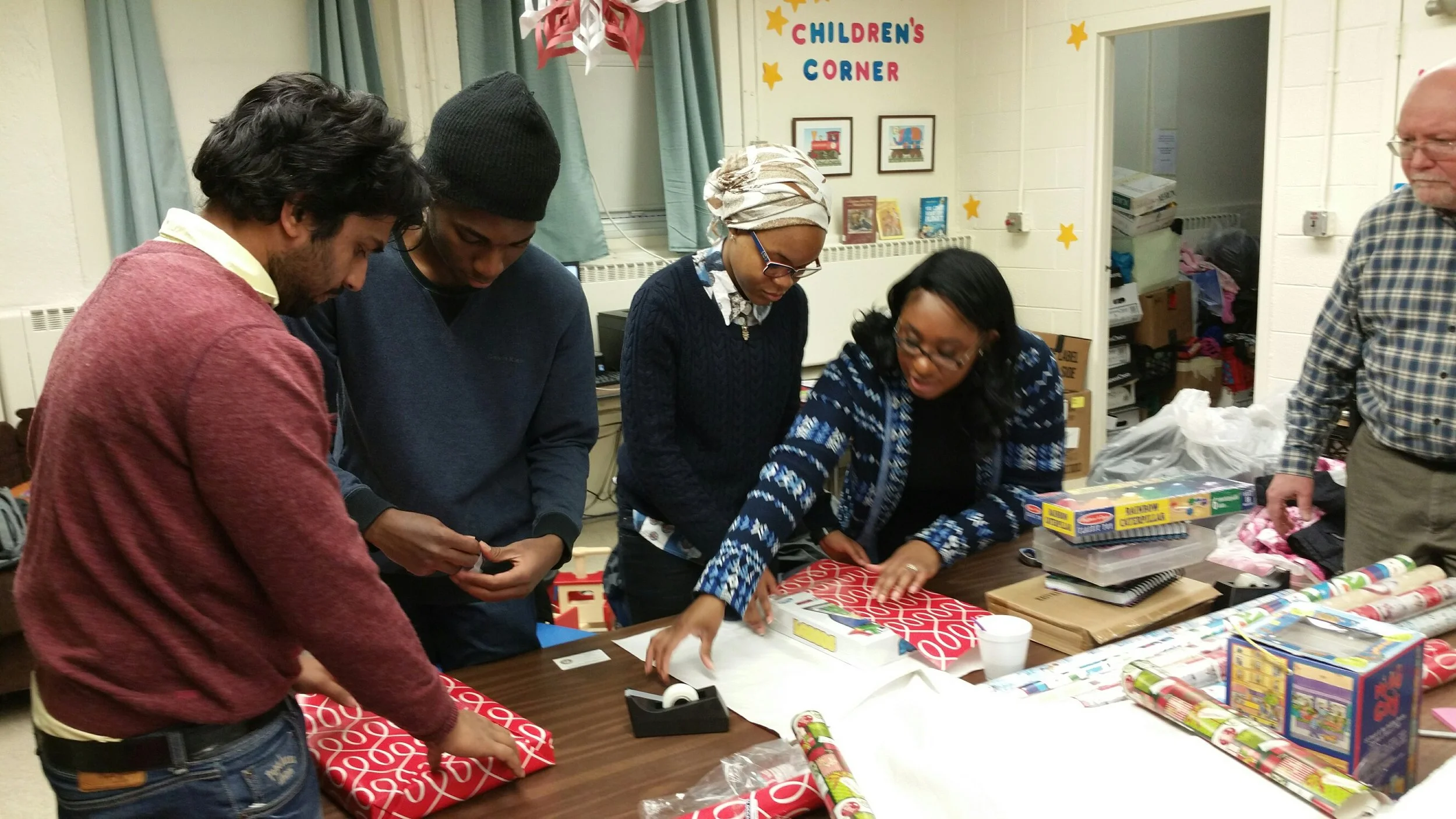 NJIT Volunteers help FARC wrap Holiday gifts for fire victims and special needs kids.