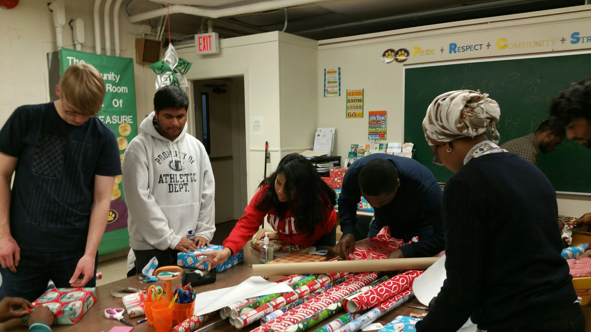 NJIT Volunteers help FARC wrap Holiday gifts for fire victims and special needs kids.