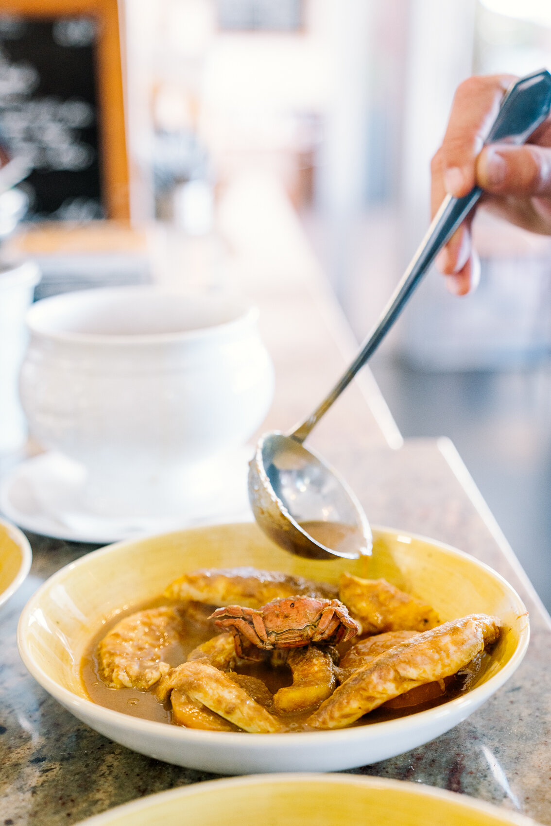  Serving Bouillabaisse at L'Esplai du Grand Bar des Goudes, Marseille.  Photo by hospitality and restaurant photographer Clara Tuma   